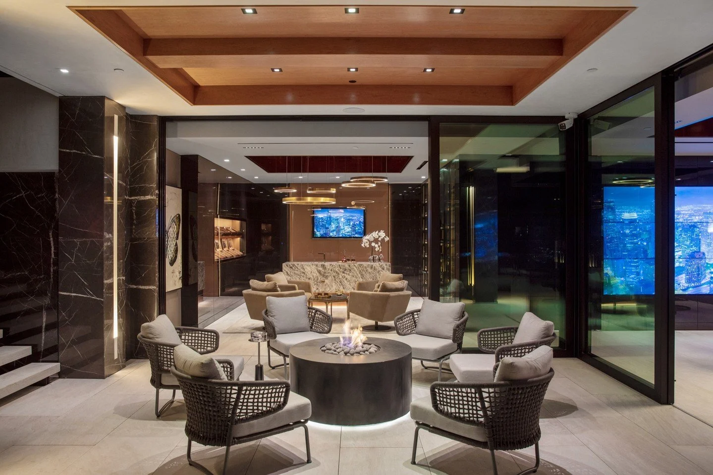 A luxury covered terrace with fire pit, outside the modern cigar lounge and game room at our Summitridge Drive house in Beverly Hills. Photo by @mrbarcelo