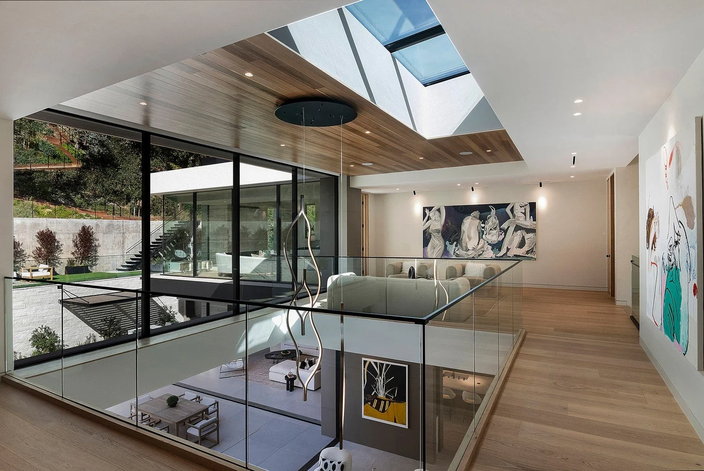 The bright, light filled upper level at our Hutton Drive 2641 house in Beverly Hills, with skylight, glass walls, and open volume atrium below. Photo by Adam Latham.