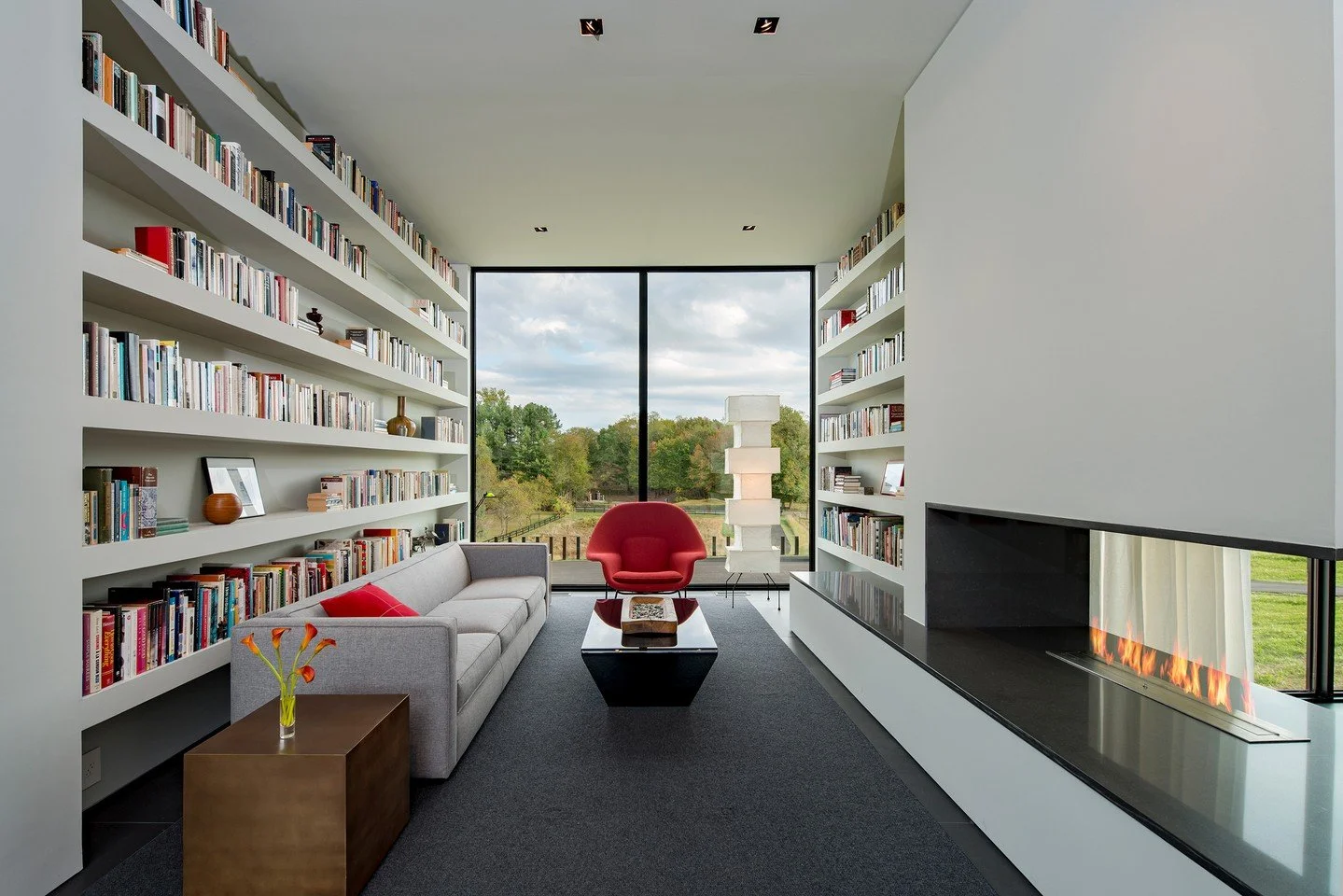 The light filled reading room and library with views at our Walker Road house in Great Falls, Virginia. Photo by @maccollum