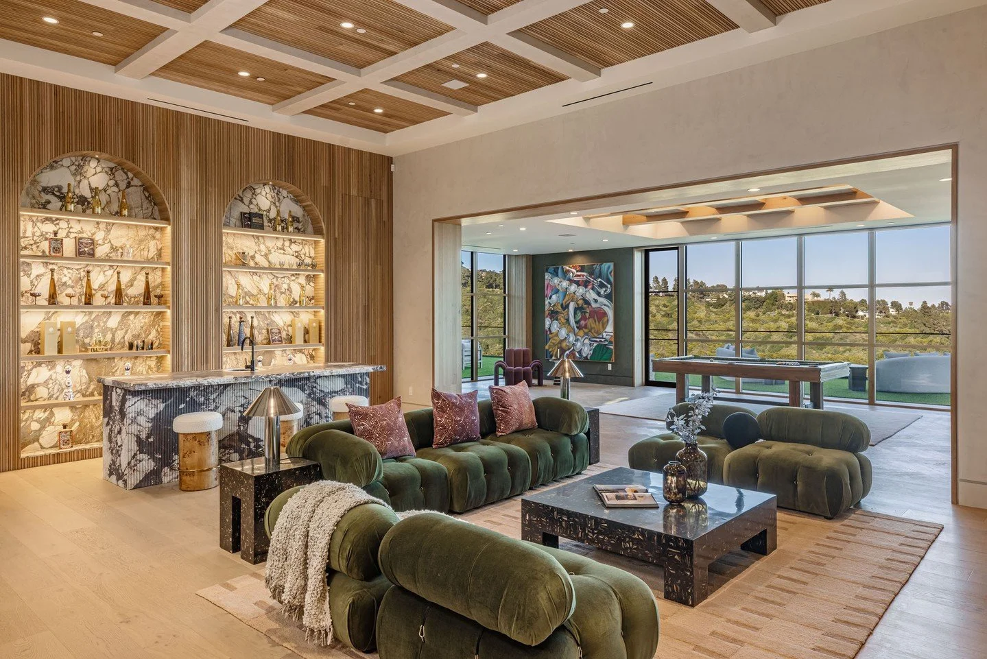 The luxury living room lounge with full bar at Beverly Crest resort style modern home in Beverly Hills. Photo by @berlynmedia