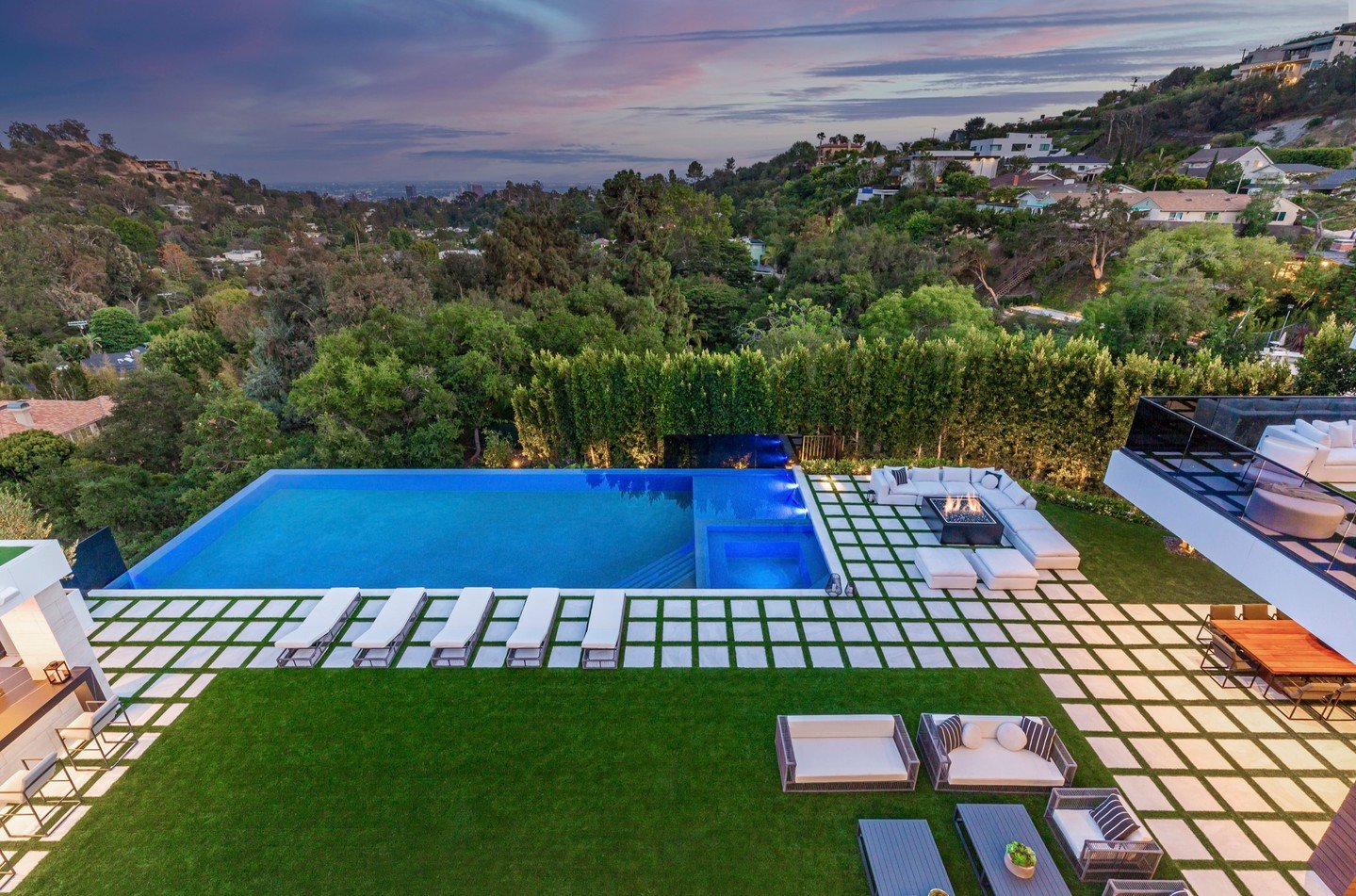 Bundy Drive's modern design extends to the backyard pool terrace, where a minimalist infinity pool sits at the edge of the Brentwood hillside property. Photos by @berlynmedia