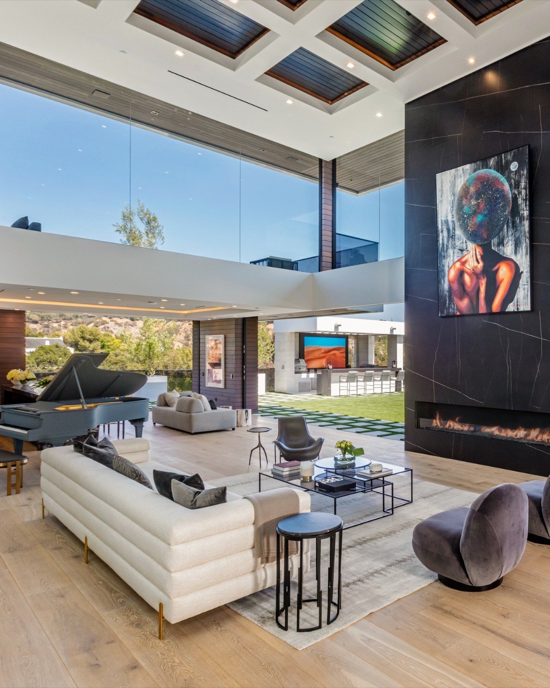 Sliding glass walls open up Bundy Drive's modern interior to the resort style backyard pool terrace. Photo by @berlynmedia
