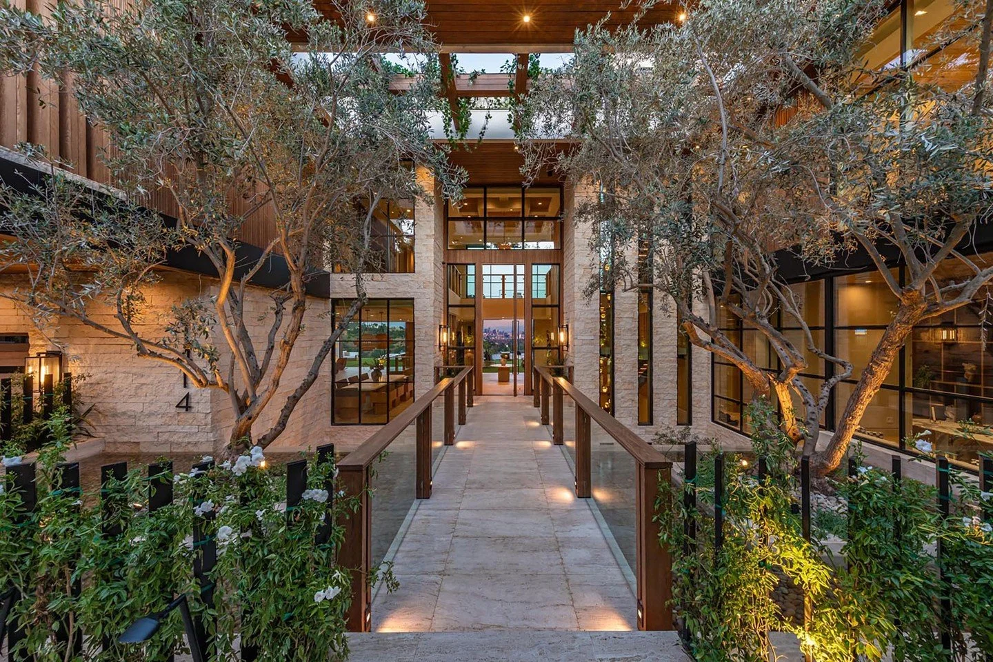 Modern lines and lush landscaping create a warm, luxurious entrance at our Beverly Crest house in Beverly Hills. Photo by @berlynmedia