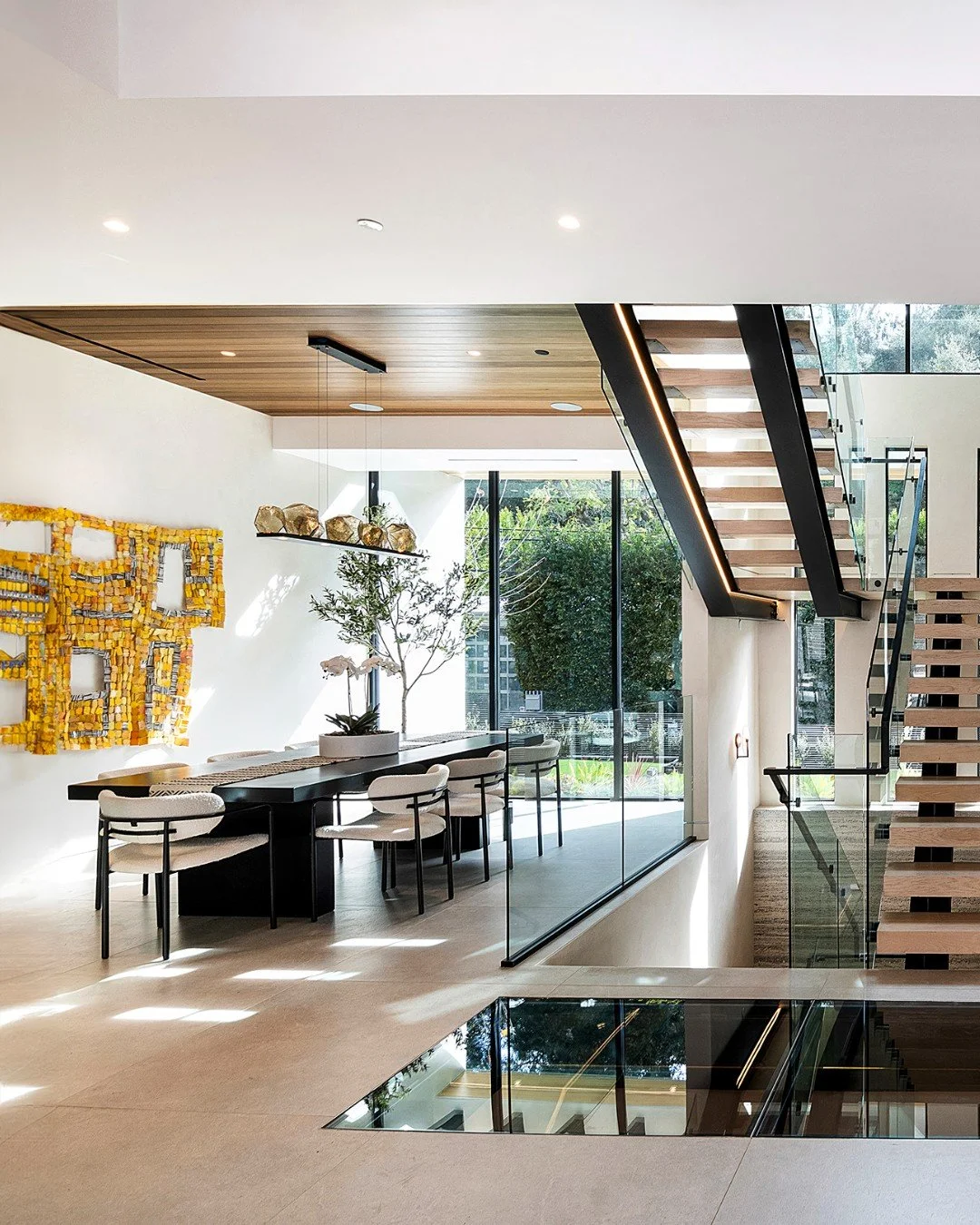 The bright, open plan interior of our Hutton Drive 2641 house in Beverly Hills, with glass walls, ribbon windows, and glass floor detail. Photo by Adam Latham.
