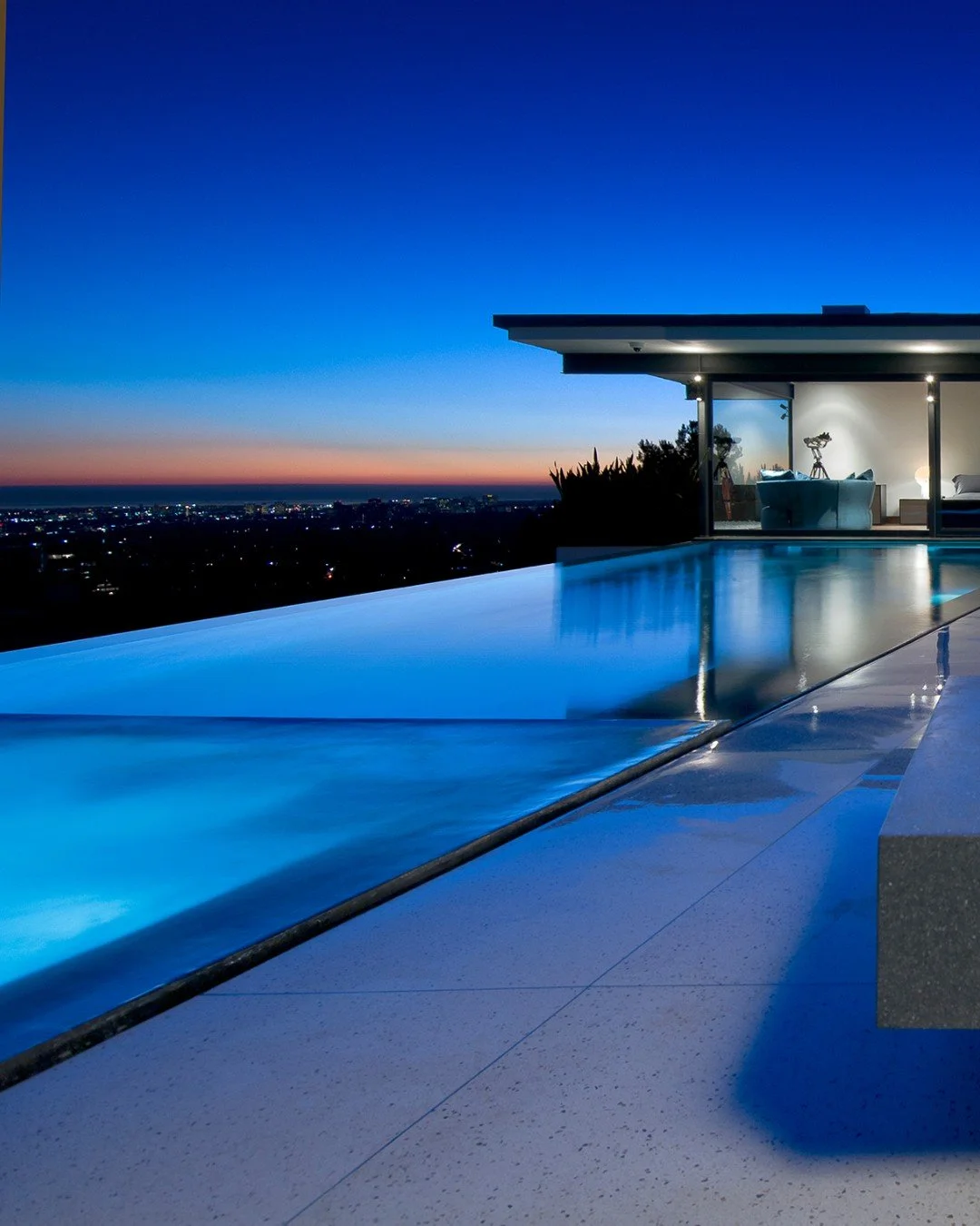 The modern design of our Hopen Place house extends to the pool terrace, where sleek lines and a floating feeling meet sweeping, expansive views. Photo by @maccollum