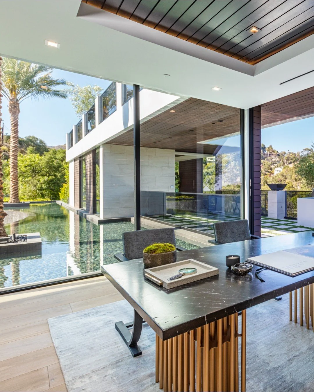 The luxury home office at our Bundy Drive house in Brentwood, Los Angeles, with glass walls and modern indoor outdoor design. Photo by @berlynmedia