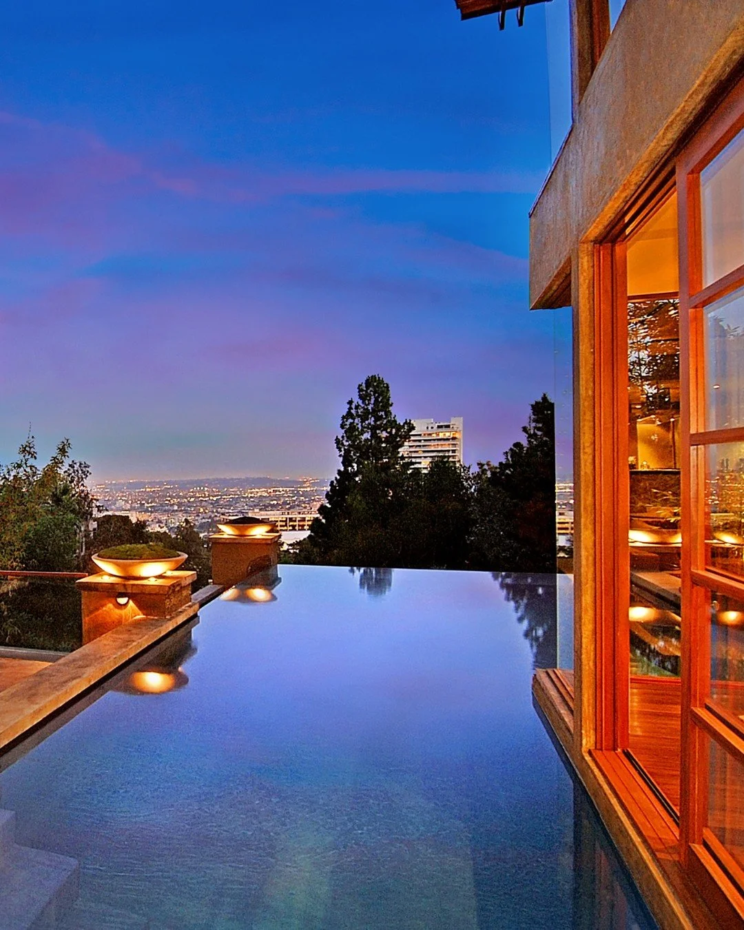 9342 Sierra Mar, an early Hollywood Hills project with warm modern design, that brings the swimming pool right up to the edge of the house for seamless indoor outdoor living.