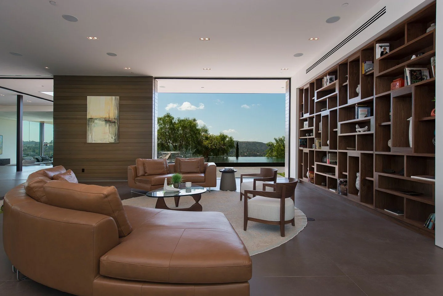The luxury living room at our Benedict Canyon 2016 house, with modern indoor outdoor design, and views that take in the surrounding landscape. Photo by @maccollum
