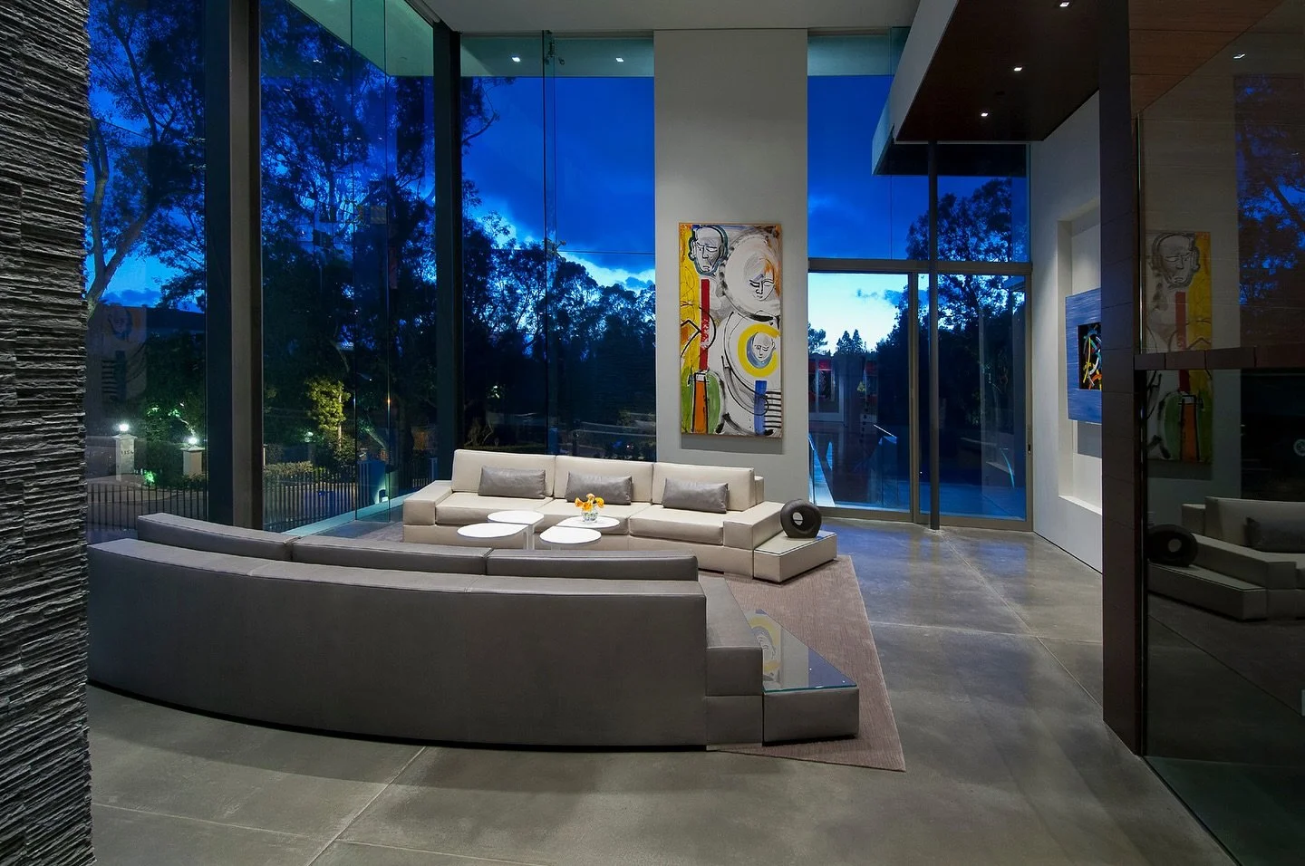 Double height glass walls, modern art, and luxury design details at our Summit House in Beverly Hills. Photo by @maccollum