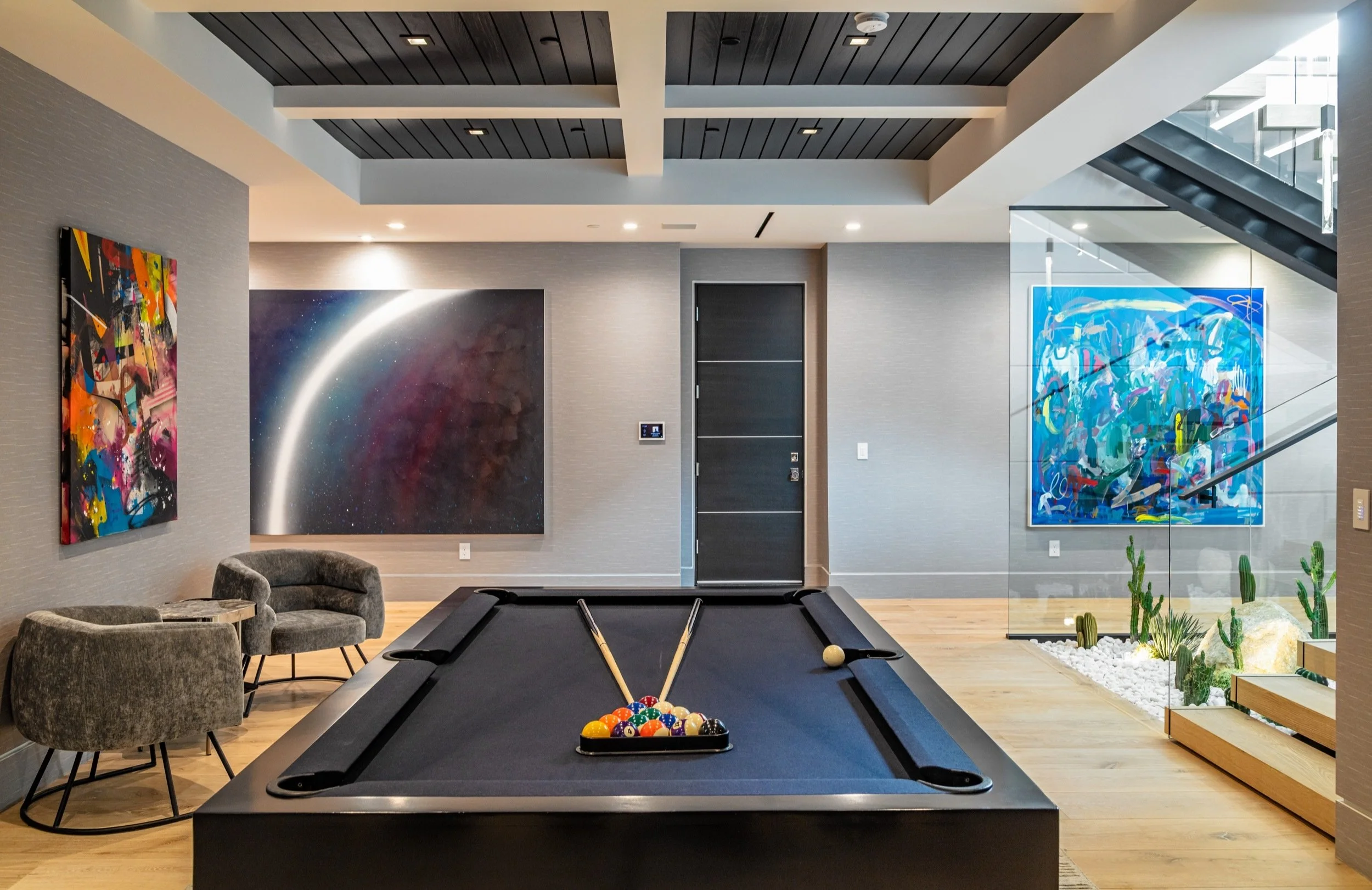 Modern game room with pool table and artworks at Bundy Drive luxury home in Brentwood, Los Angeles