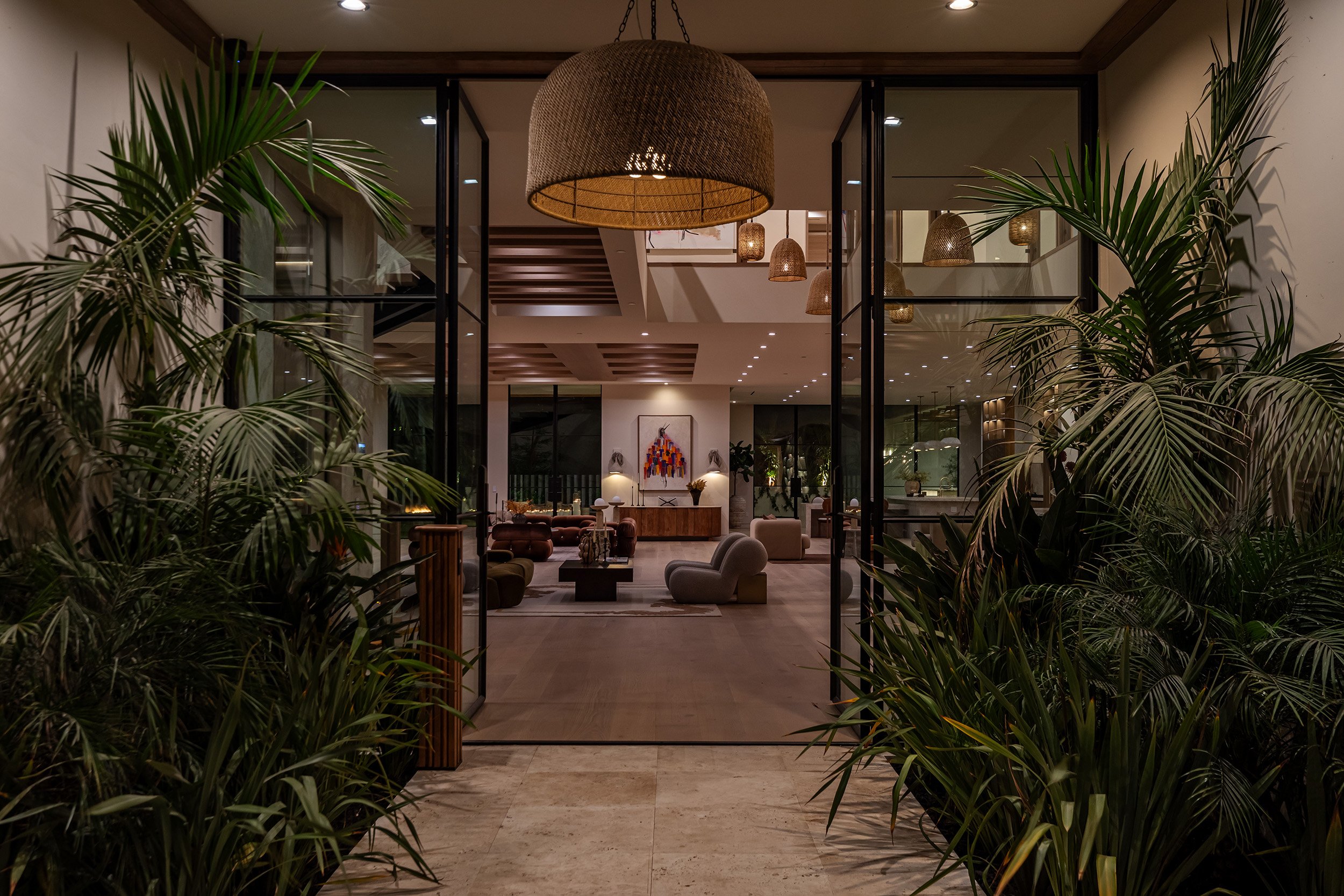 Franklin Canyon Beverly Hills luxury home with modern glass wall entryway into a spacious open plan design