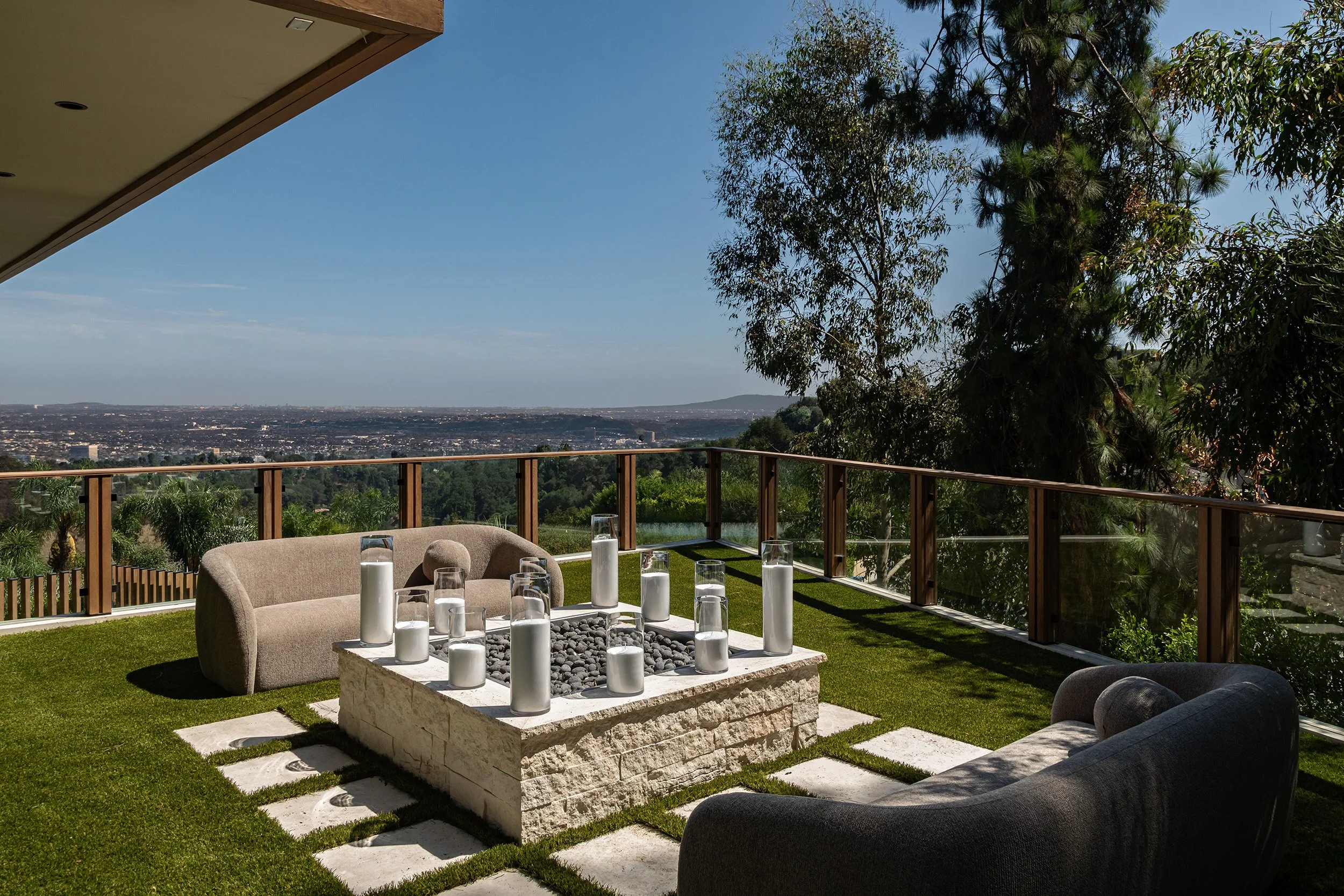 Franklin Canyon Beverly Hills modern home primary bedroom terrace with fire feature & views