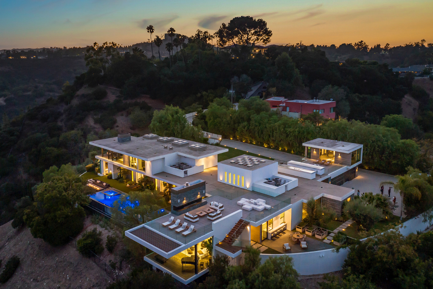 Benedict Canyon modern Beverly Hills home at dusk with indoor outdoor design and modern rooftop terrace lounge