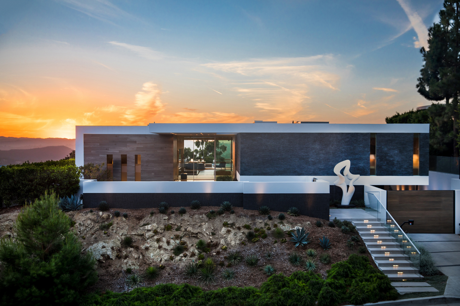 Trousdale Beverly Hills modern architectural luxury home with glass walls and stacked stone exterior