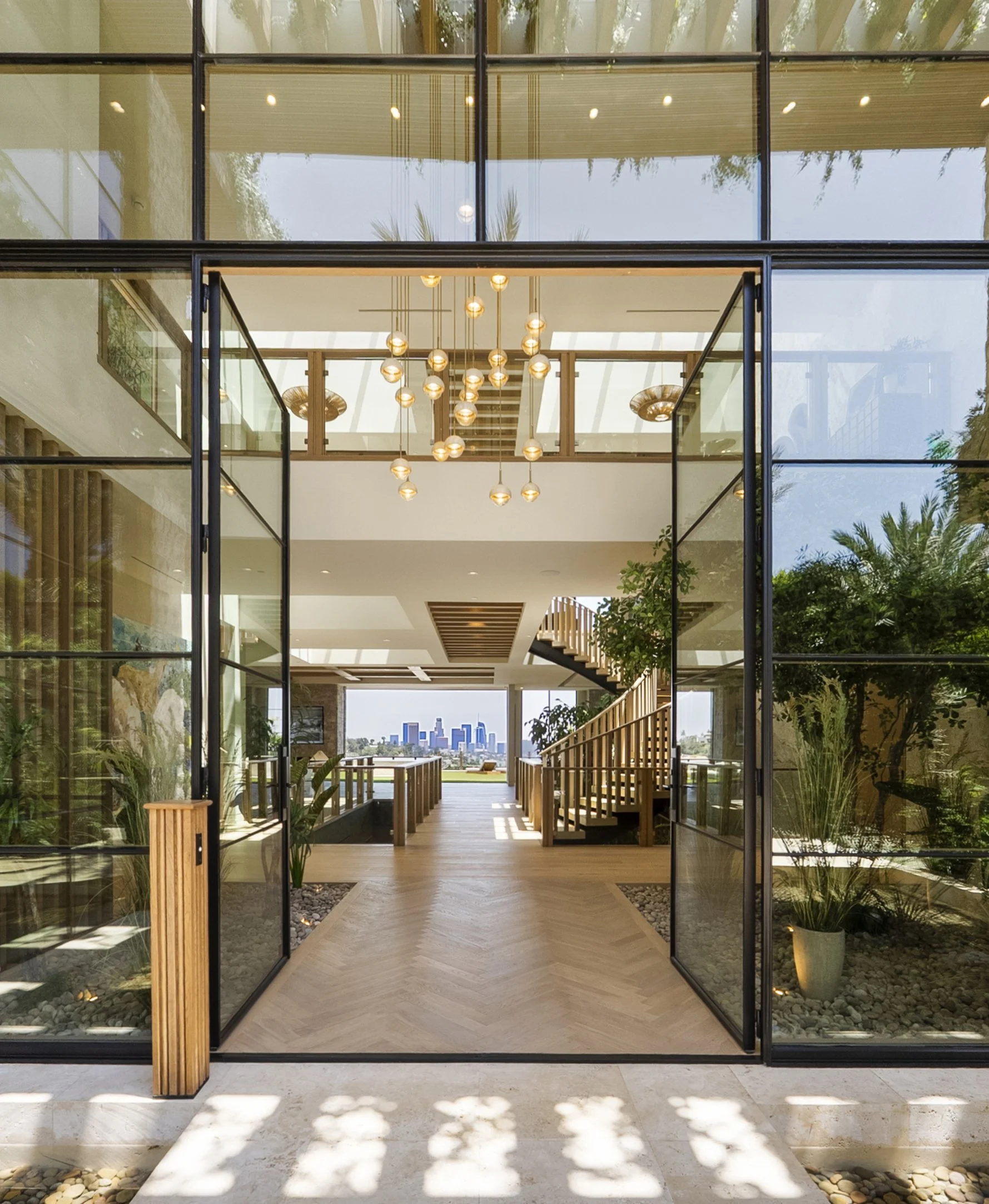 Laurel House Beverly Hills modern home light filled foyer and glass wall entry