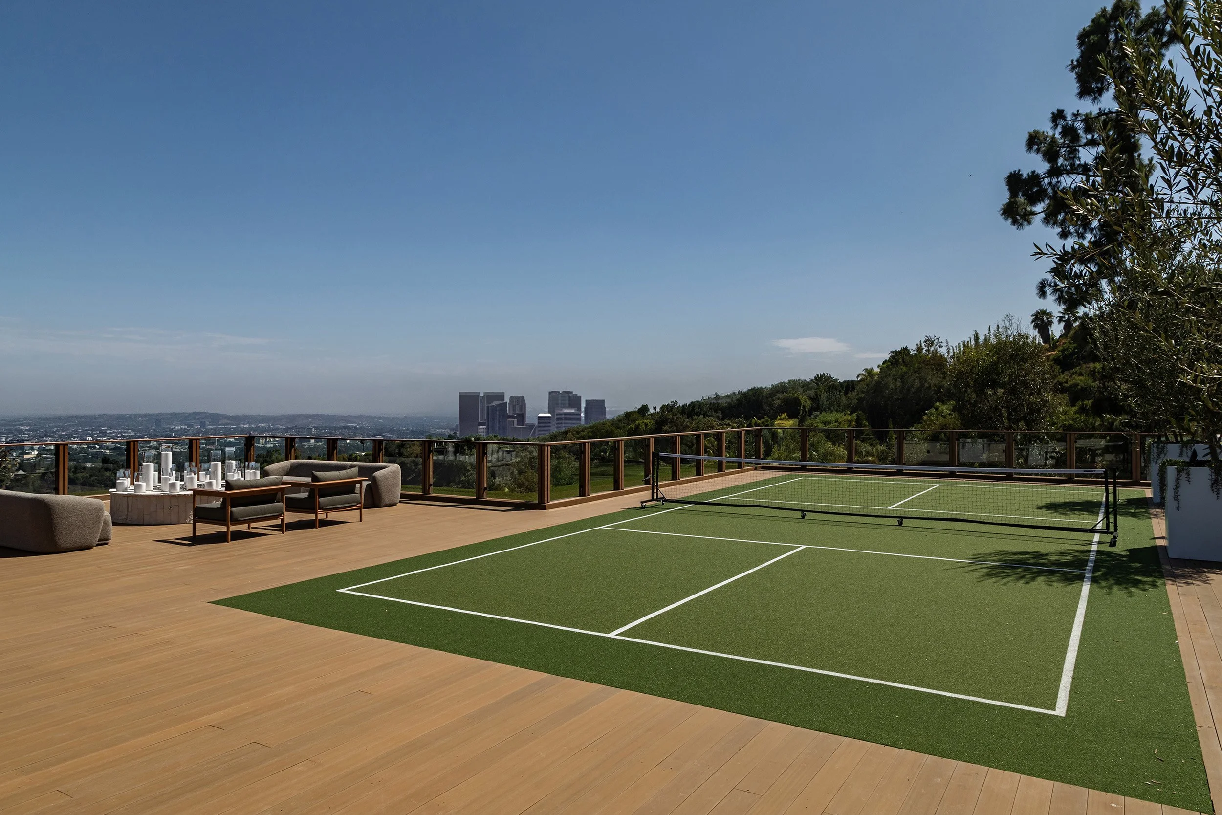 Franklin Canyon Beverly Hills luxury home modern rooftop tennis court & lounge with views