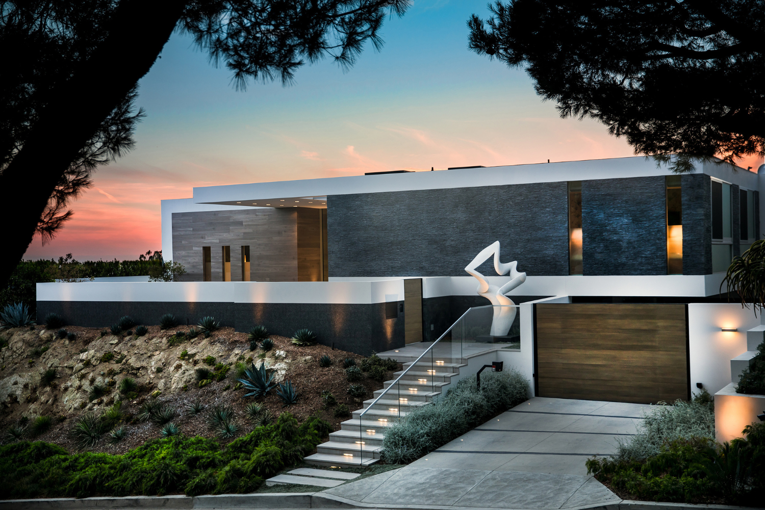 Trousdale, luxury home modern exterior with textured stacked stone & marble Richard Erdman scupture