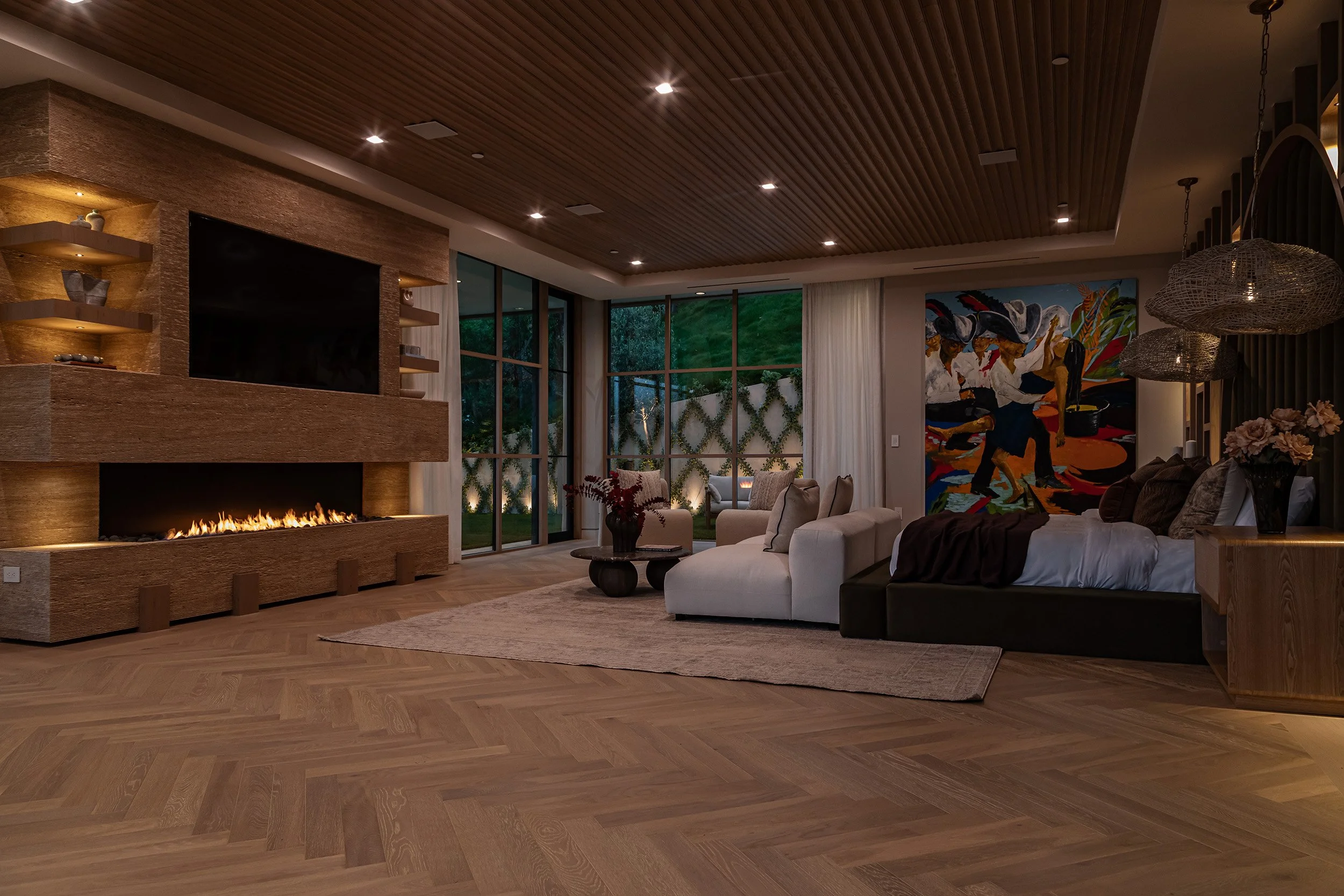 Franklin Canyon Beverly Hills luxury home modern primary suite with fireplace at night