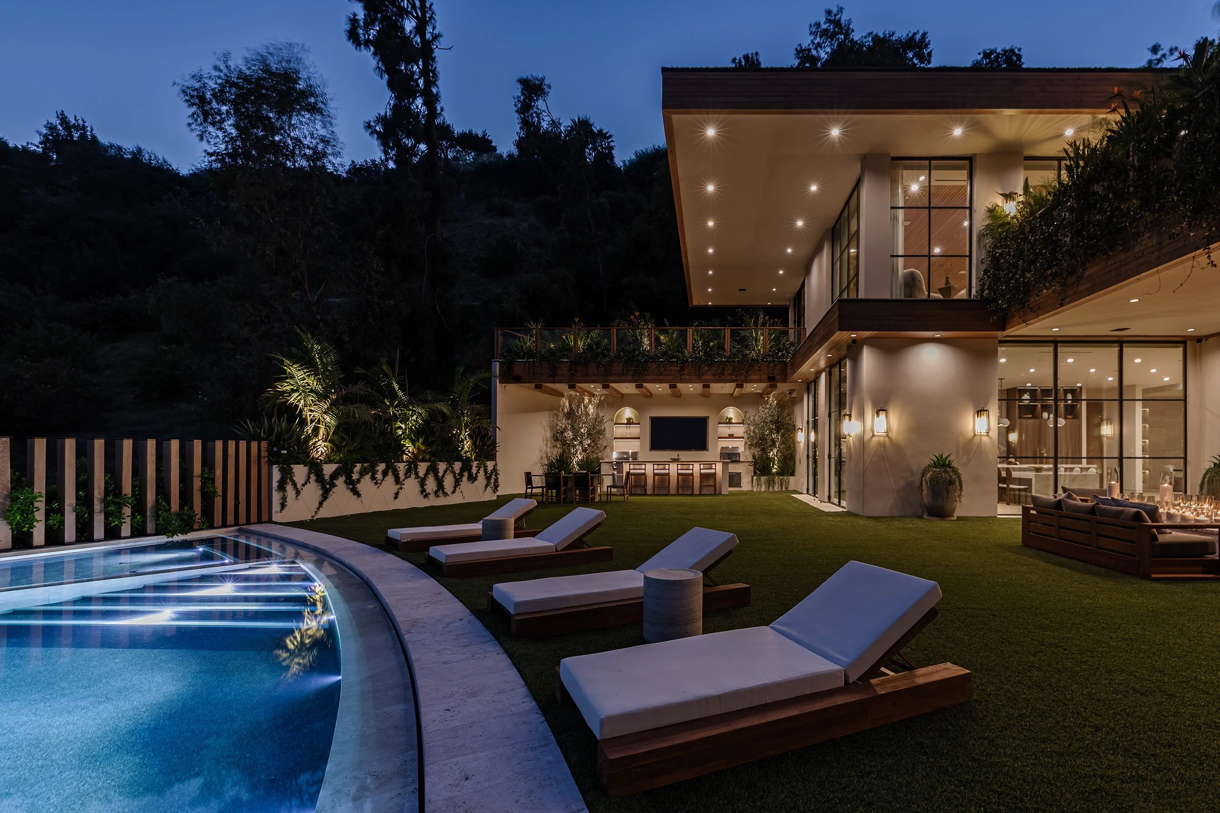 Franklin Canyon Beverly Hills luxury home with modern pool terrace lit at night