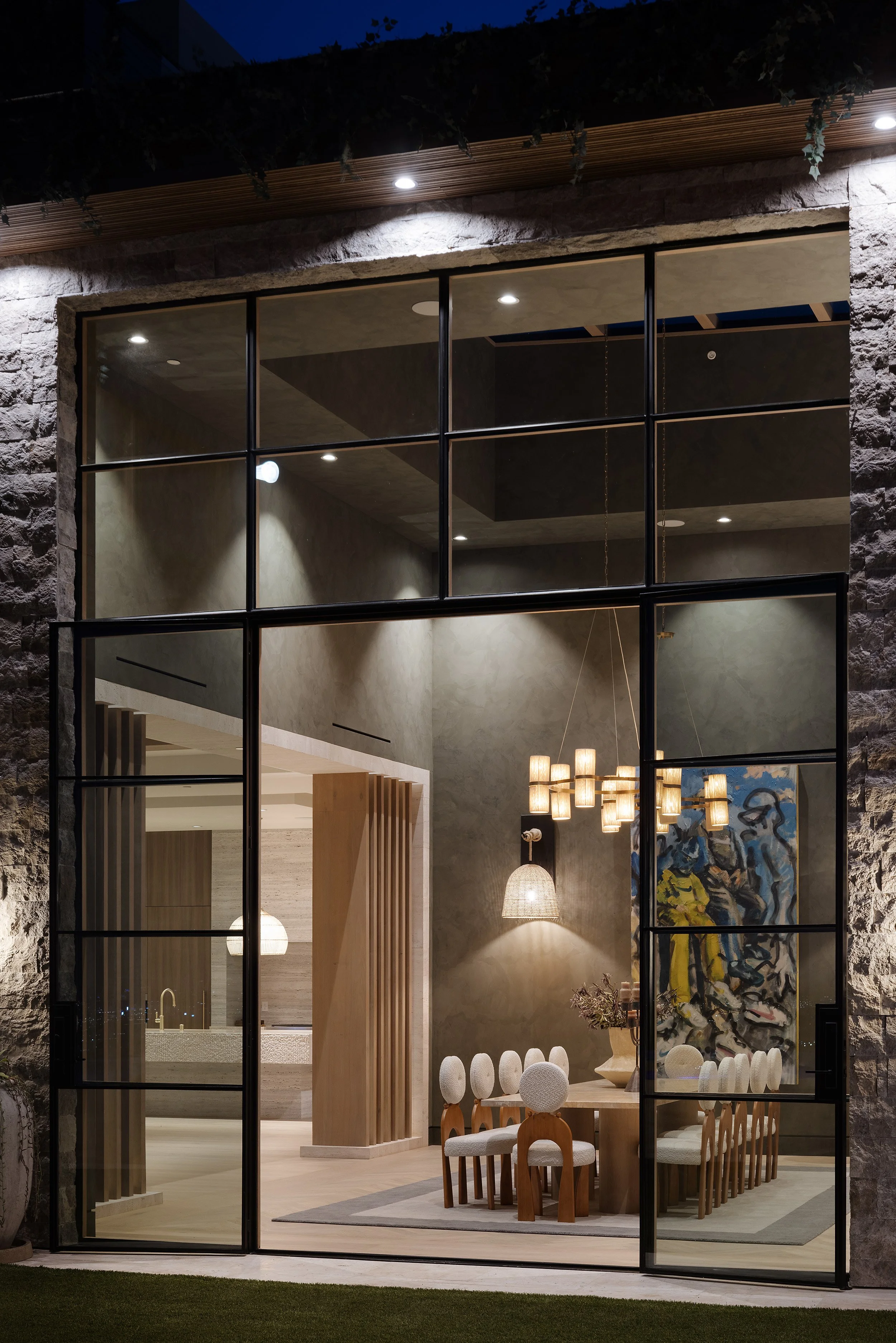 Laurel House Beverly Hills luxury home modern dining room at night with indoor outdoor glass wall entry