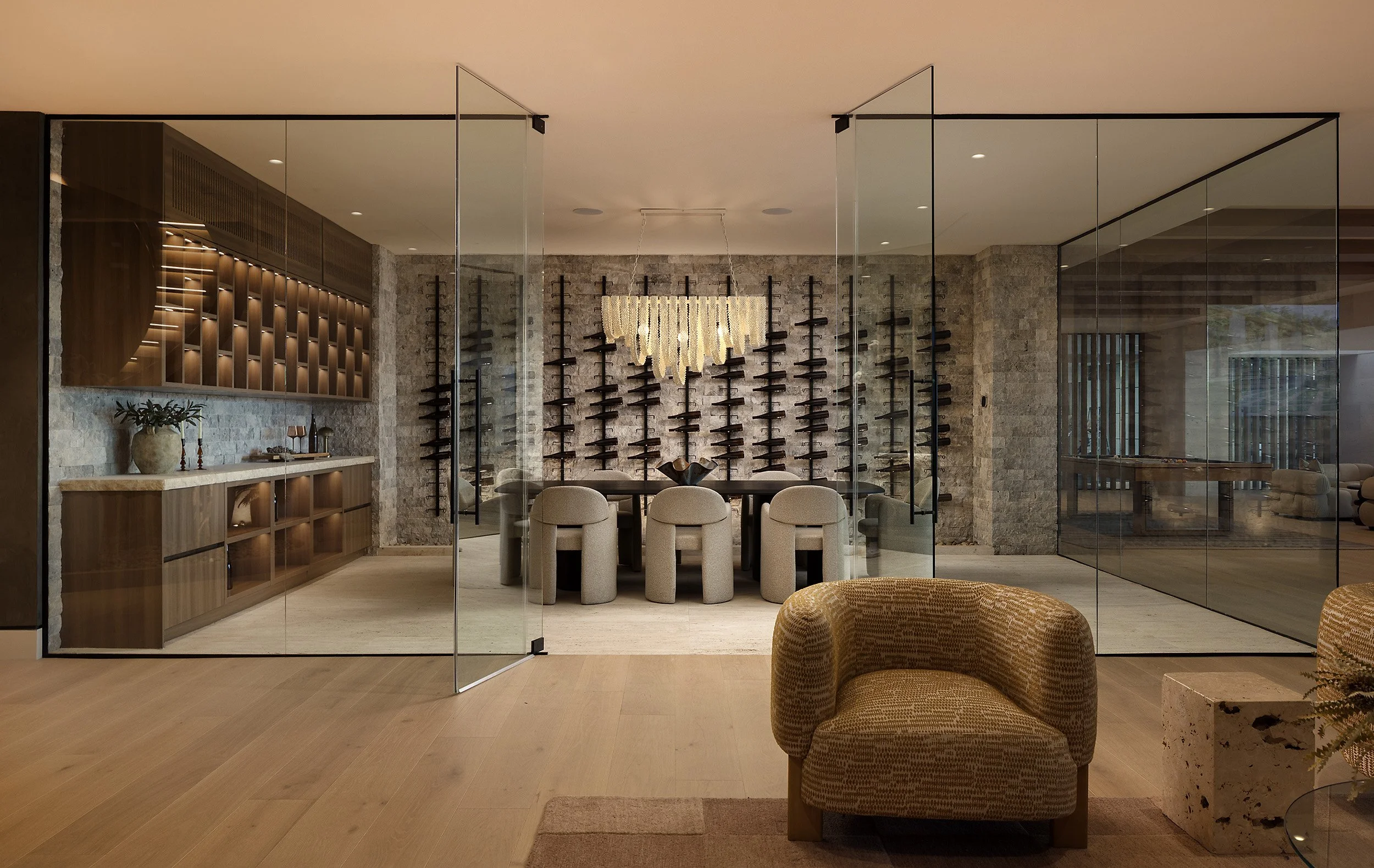 Laurel House Beverly Hills luxury home modern glass enclosed wine cellar with dining table and bar