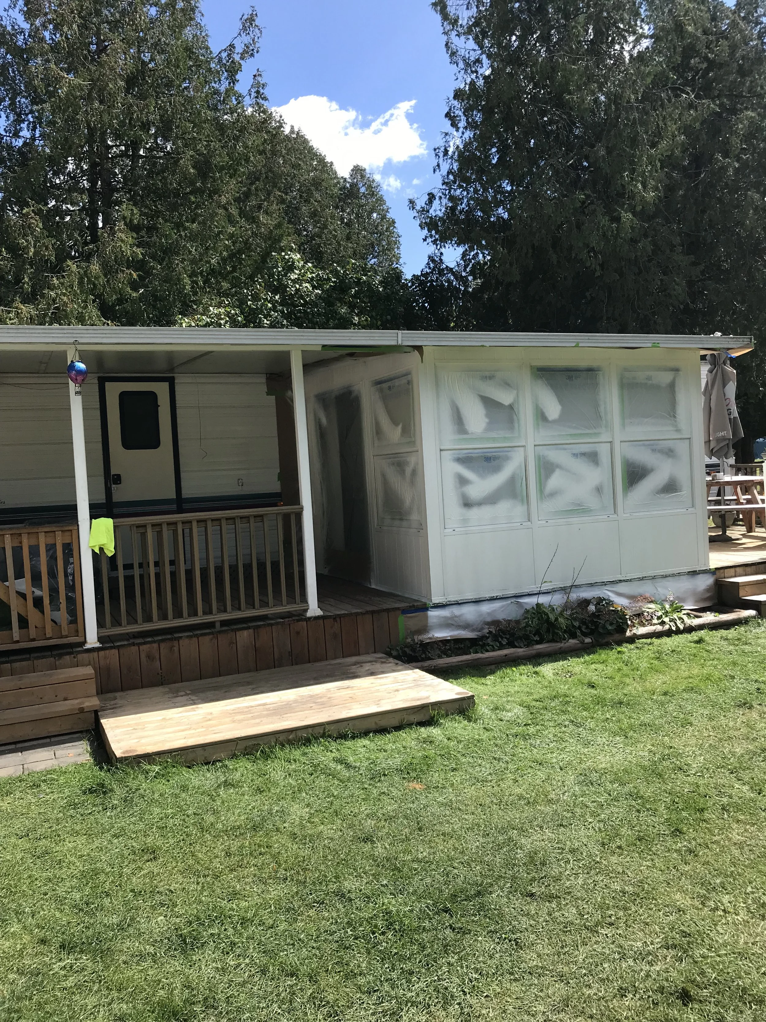 Oil primer applied to aluminum siding of trailer, followed by two coats of acrylic exterior satin paint 