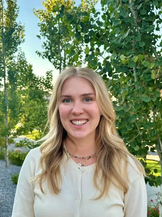 Photo of Olivia Merrill smiling, outside.
