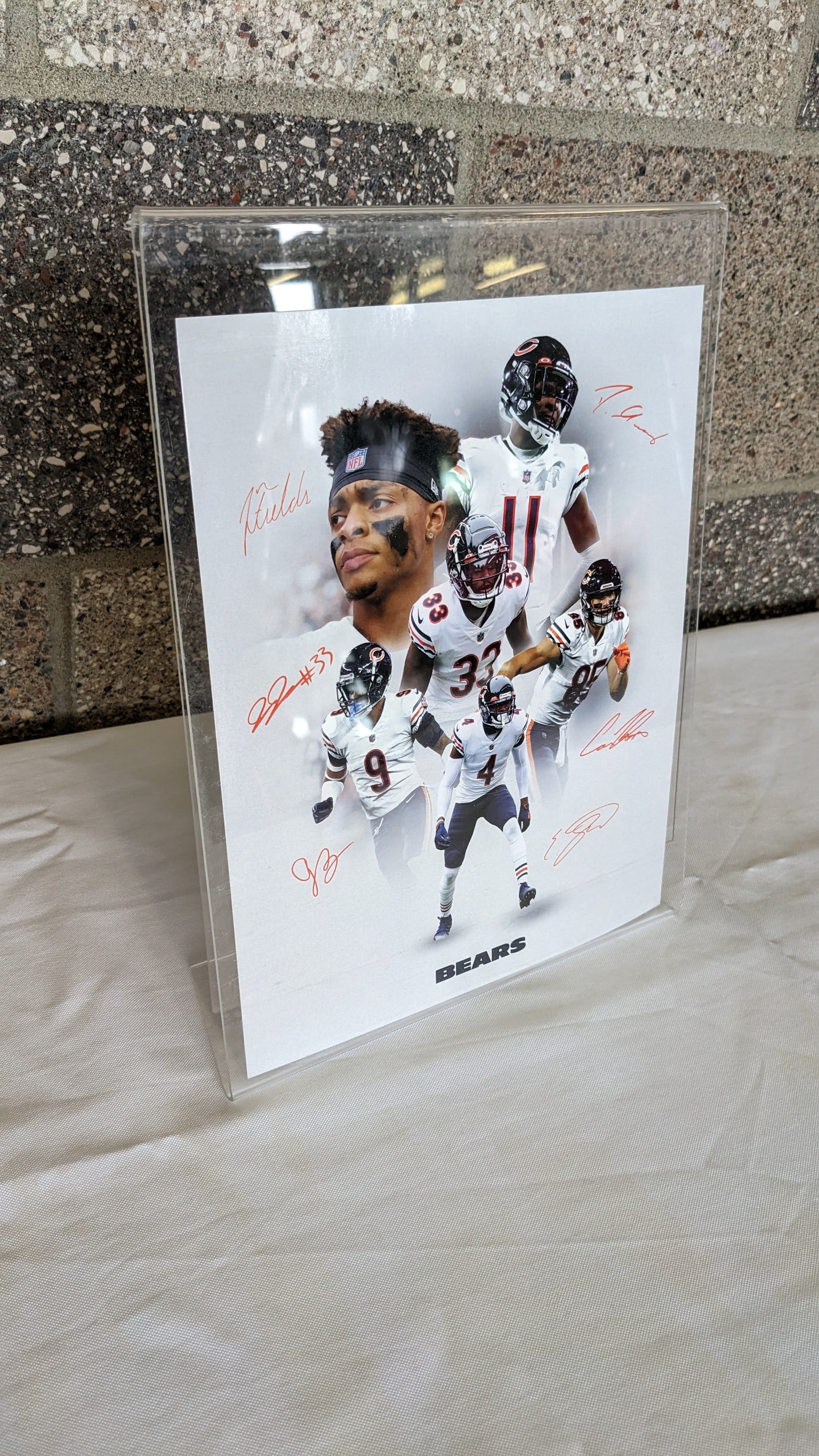 Signed print of Chicago Bears players - donated by Chicago Bears. Bundled with $25 gift card to Jethro's BBQ. Value: $75. Minimum bid: $40.