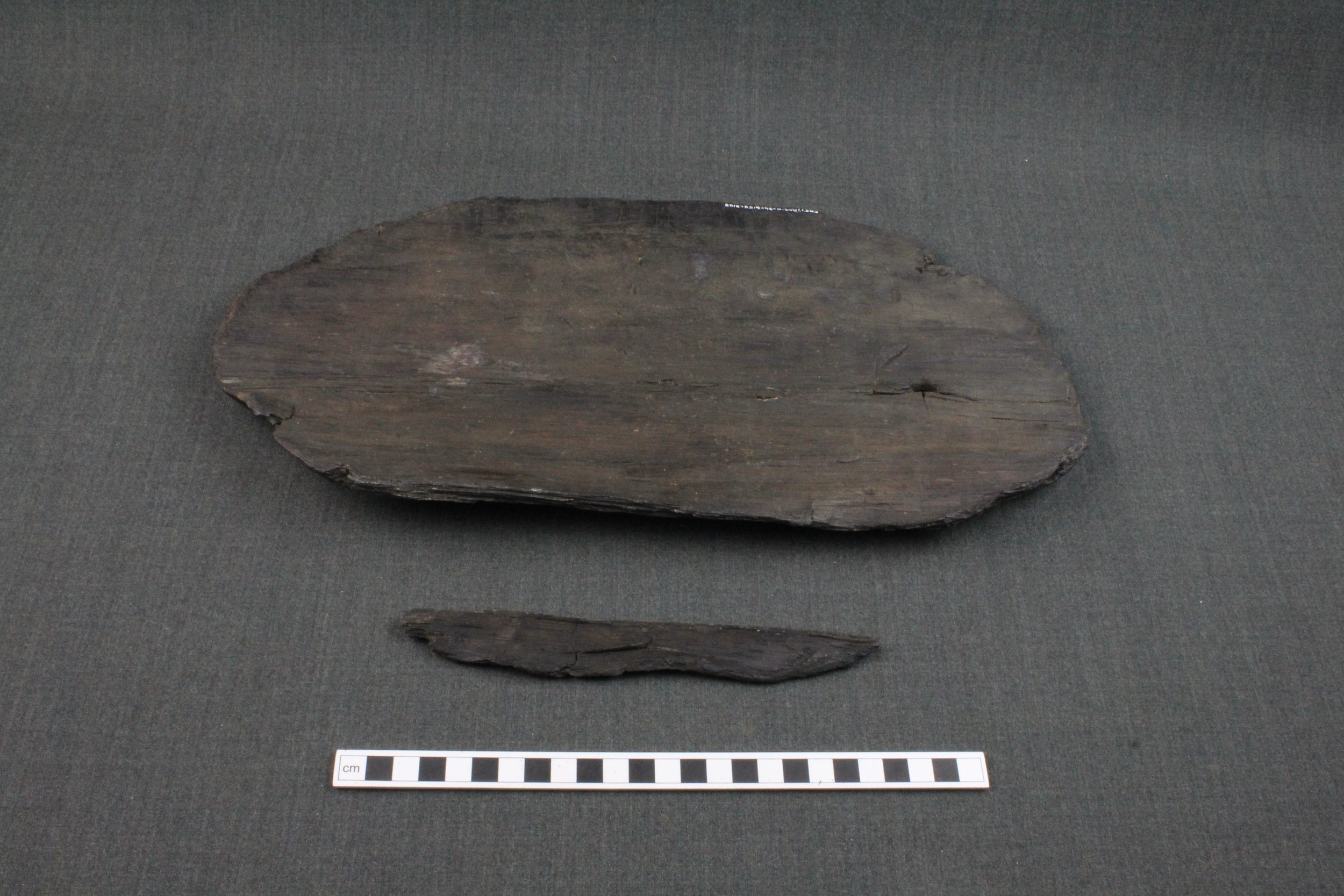 13th century platter with a perforation at one end