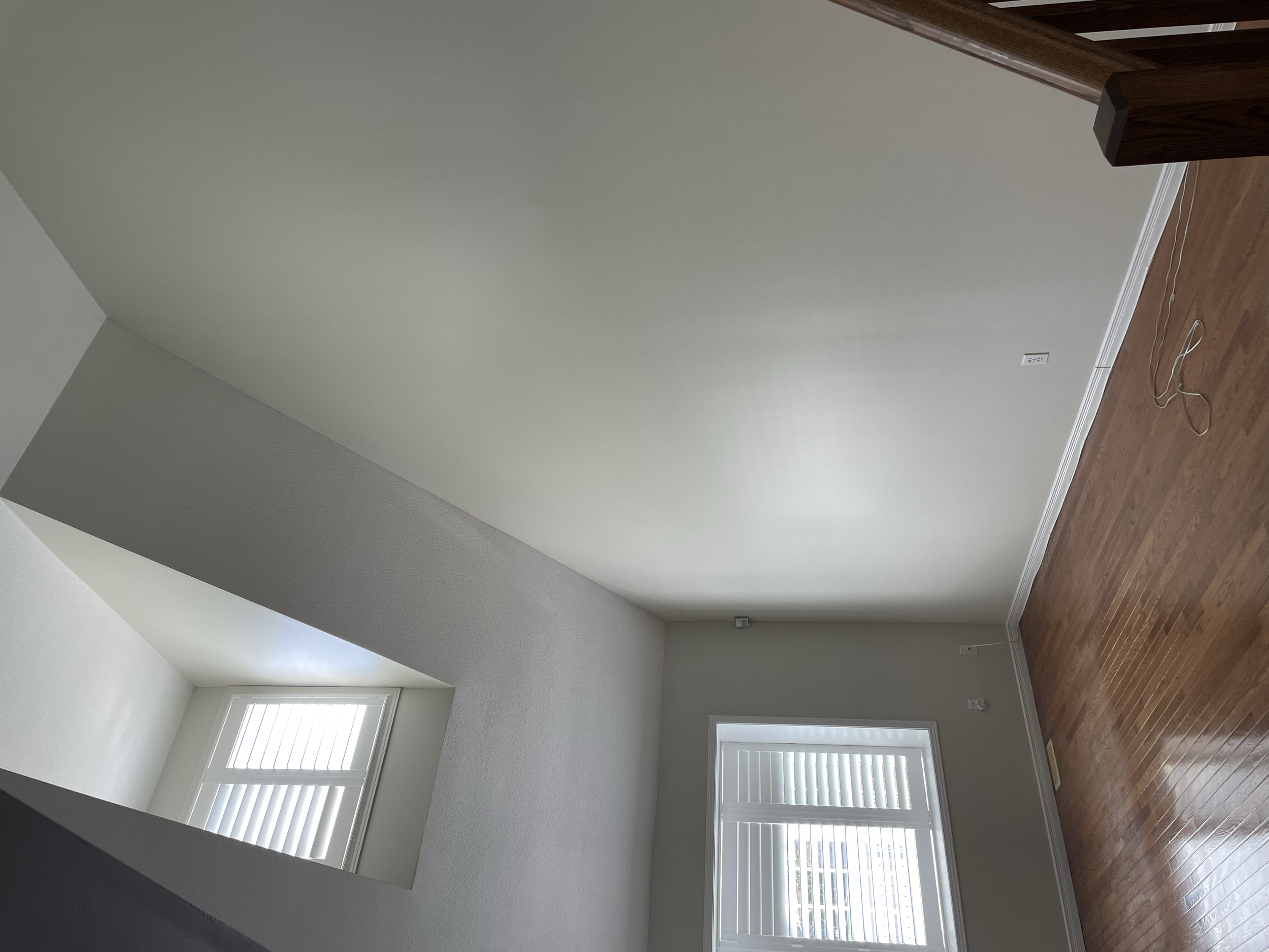 Empty room with three windows with white shutters, hardwood floors, and white walls.
Interior House Painting. Heather Feather Painting and Design. Toronto.