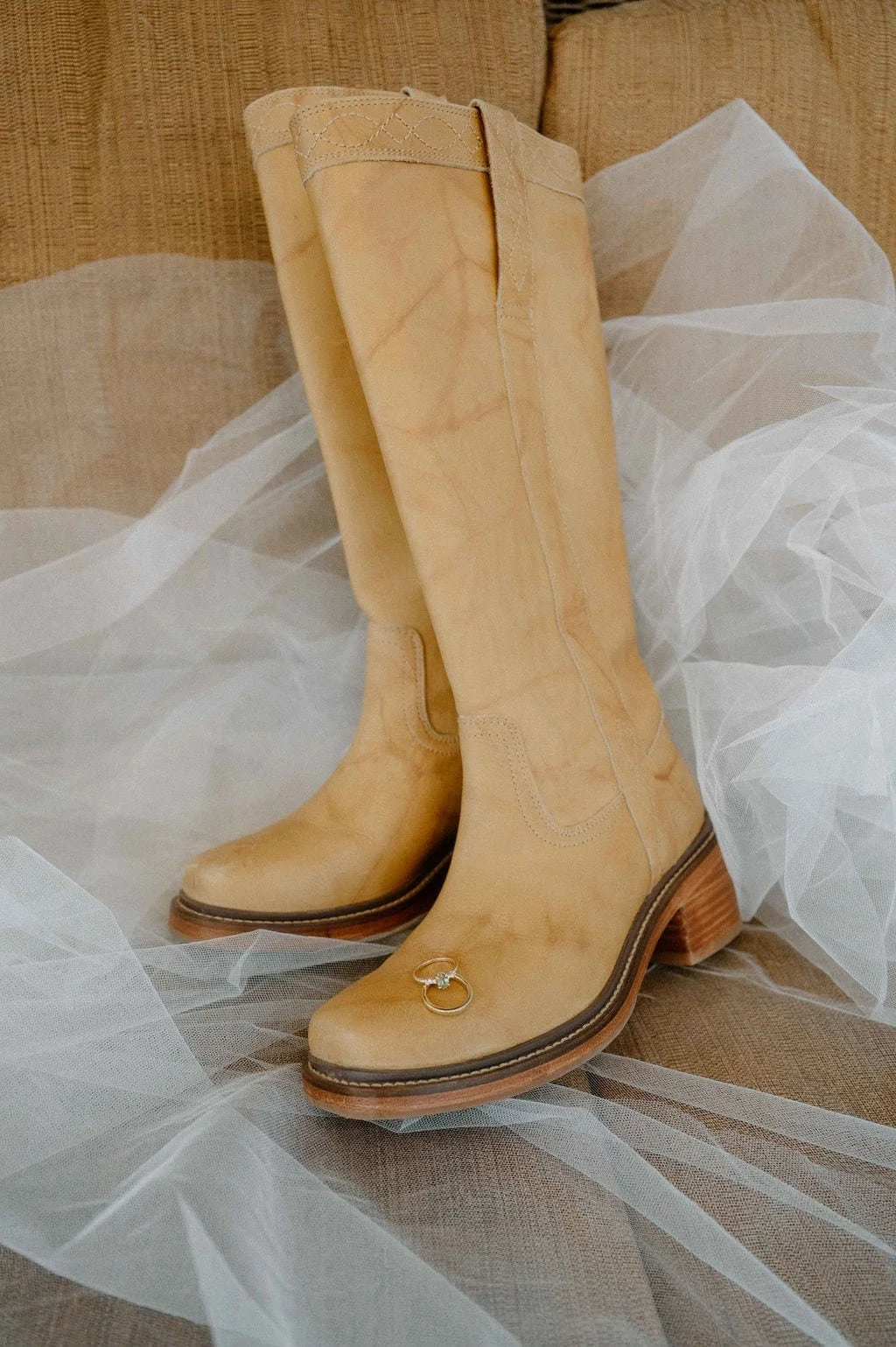 Bride wearing Frye boots for rustic wildflower wedding in Colorado