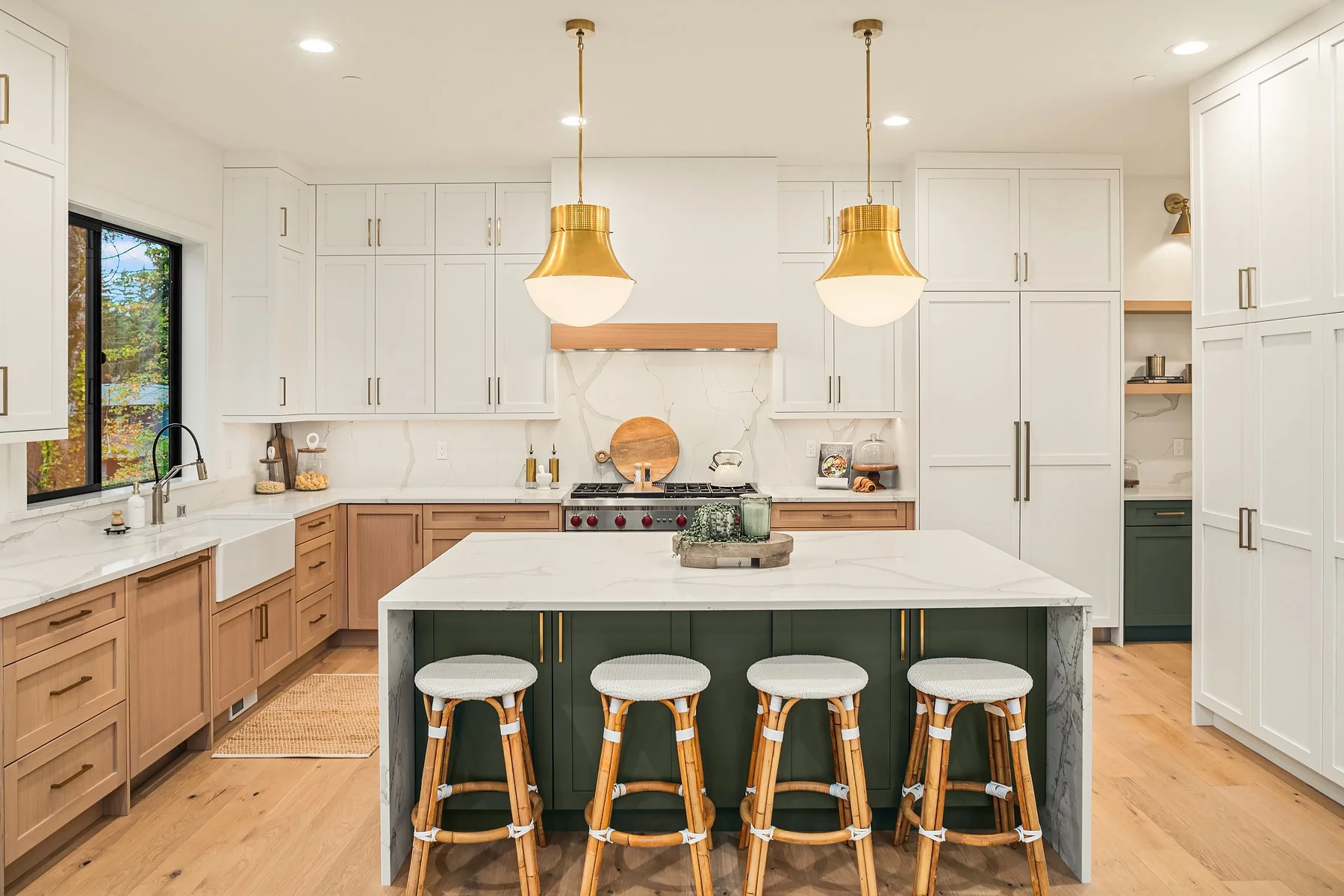 “High‑end Kirkland WA kitchen with white quartz island, wood cabinetry, and gold pendant lights with open space