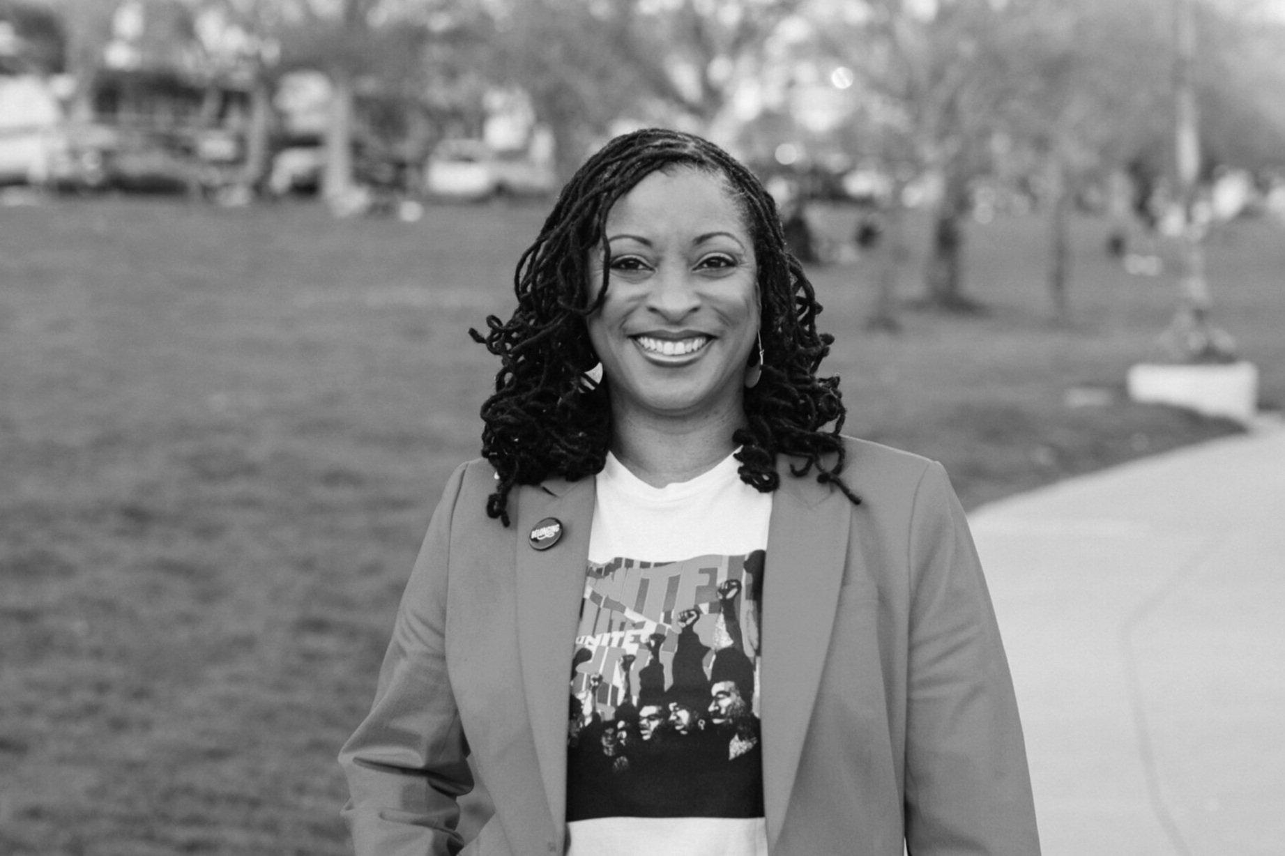 Black and white photo of LaShawn smiling with her hand on her hip