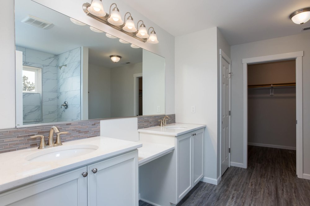 modern white master bathroom with vanity section