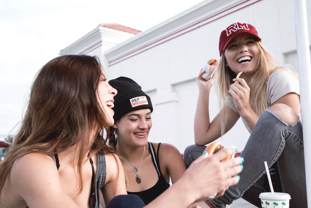 girls wearing rep meddy laughing at in n out