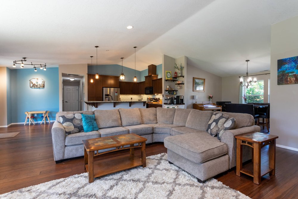 large sectional sofa in open floor plan living room in Adair home in Tangent Oregon