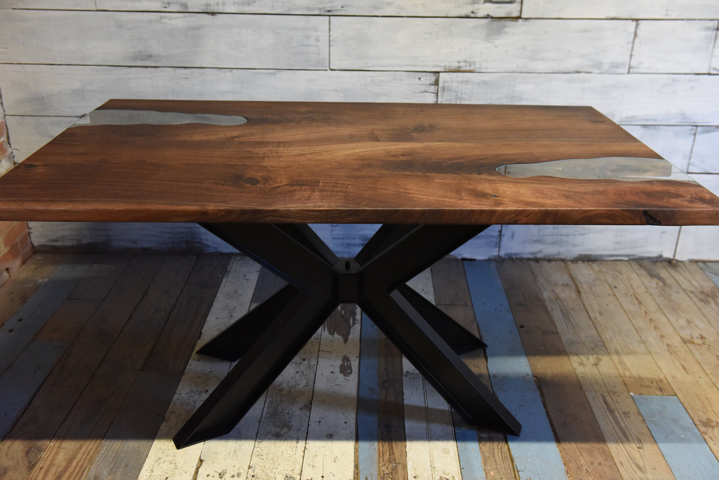 straight cut walnut slab with double glass inlay on "spider" base.