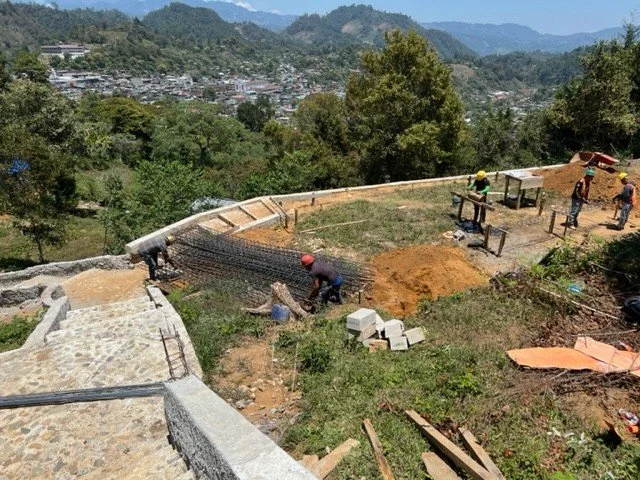 In 2022, the HOREB campus was still taking shape on the hillside above San Juan Cotzal.

These photos show some of that growth over the next few years, from early foundation work and the first school building taking shape to more classrooms and the c