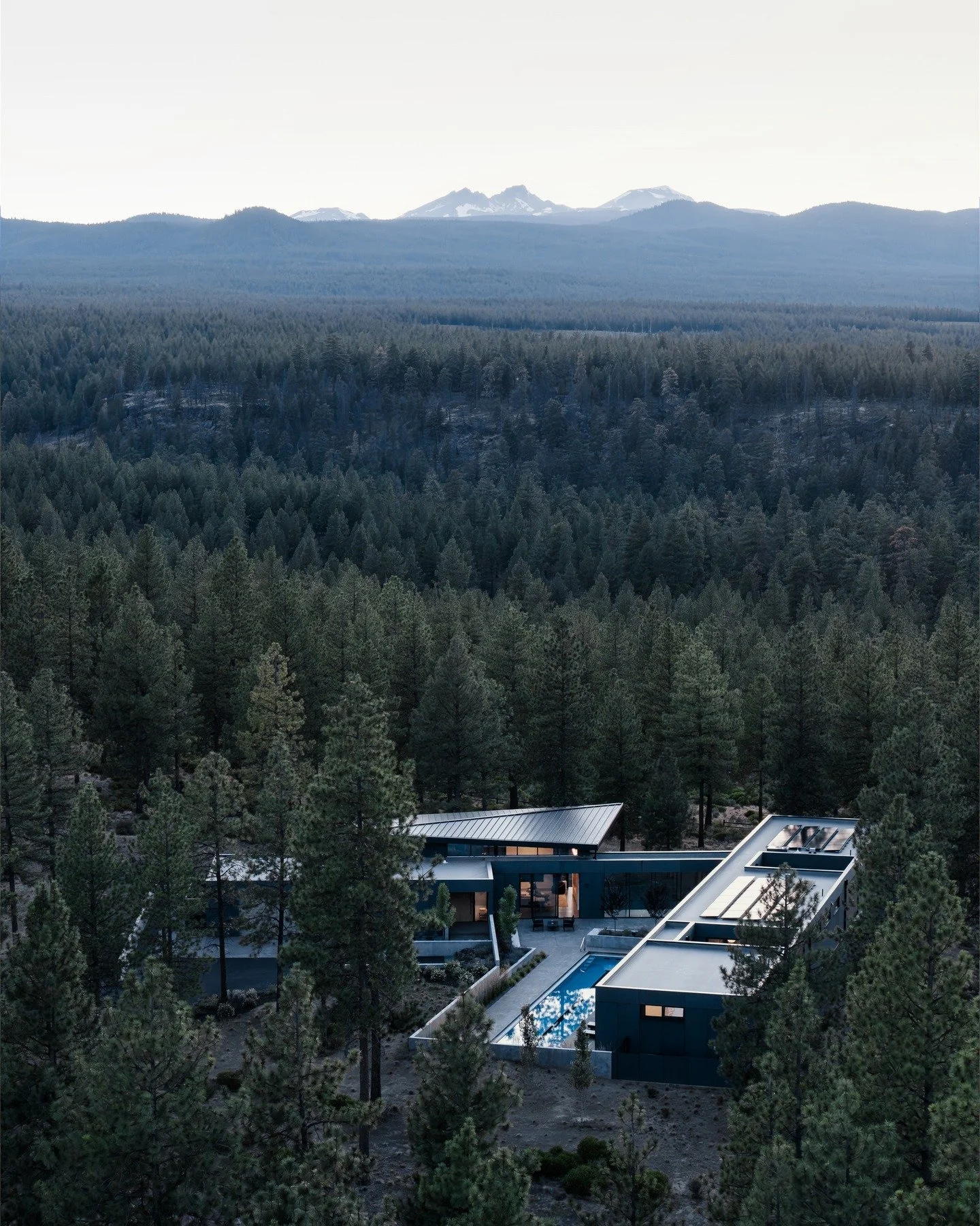 Hideaway &mdash; a single-level home built for movement.

The brief was simple: space for family life, two dogs, and daily training. We delivered a ground-hugging plan with a lap pool, home gym, and walls of glass that open to the pines. The house be