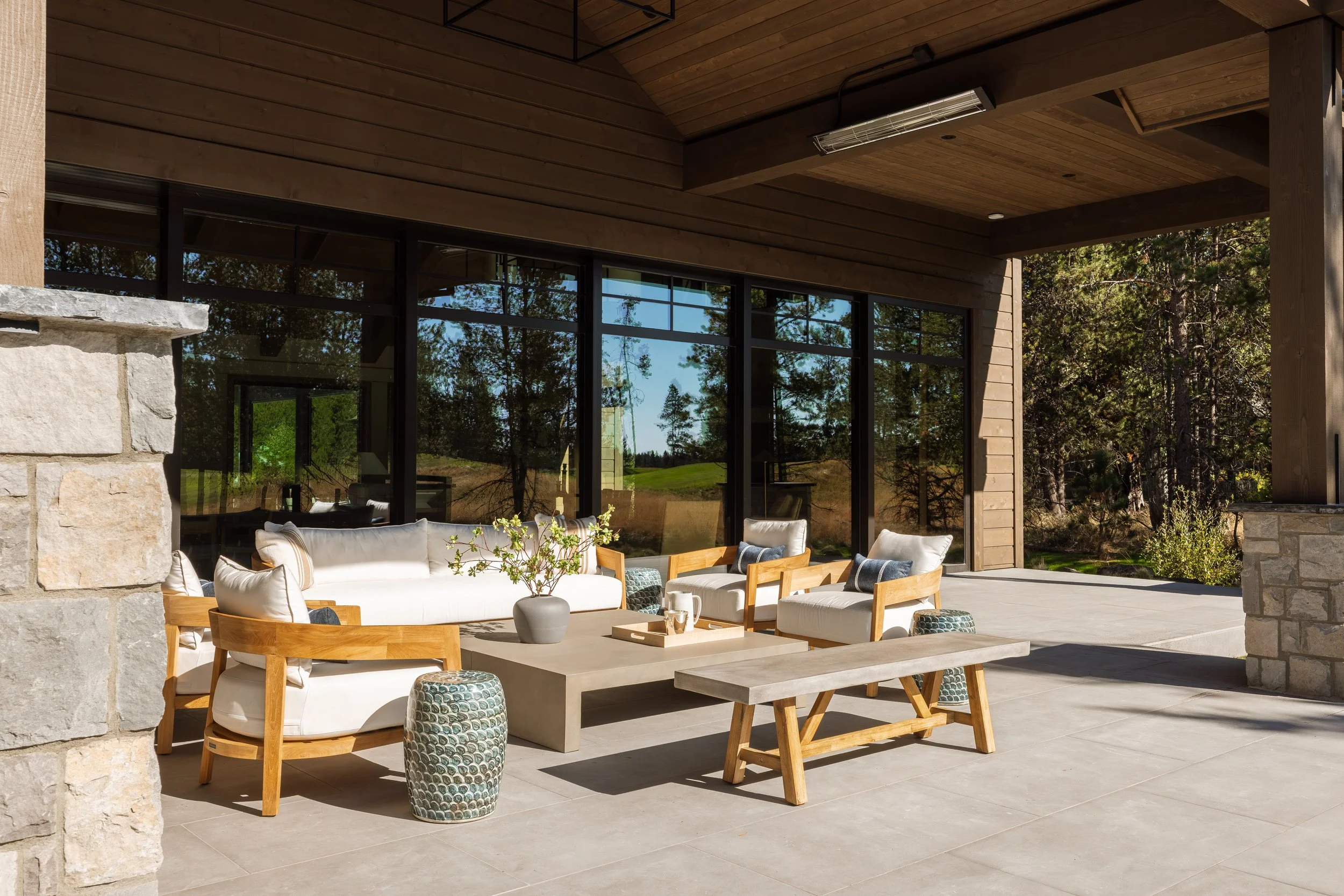 Covered outdoor living room with stone columns.