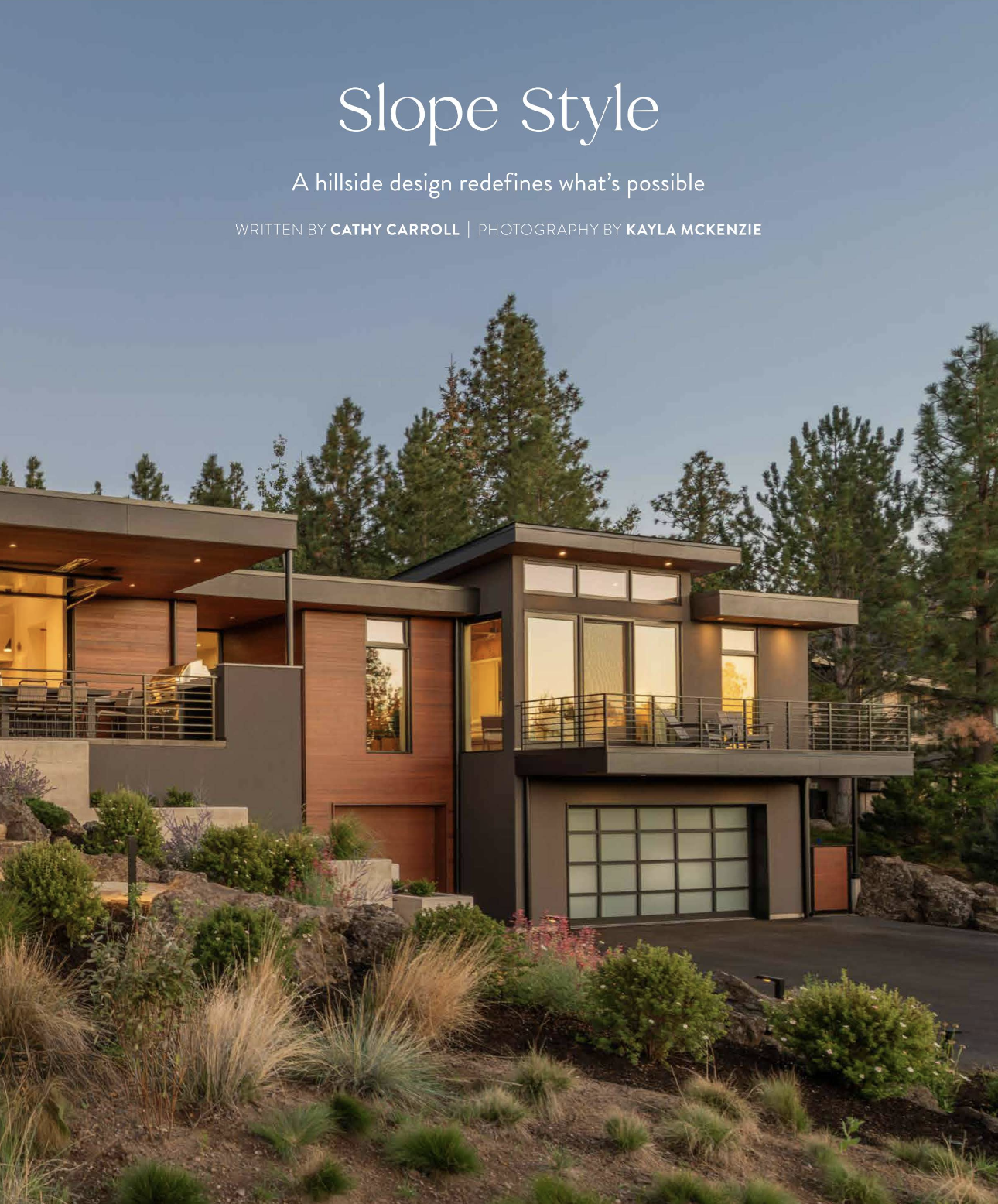 Modern hillside home at dusk with wide covered deck, terraced landscaping, and warm wood ceilings — Overlook by Copperline Homes, featured in Bend Home + Design, Bend, Oregon