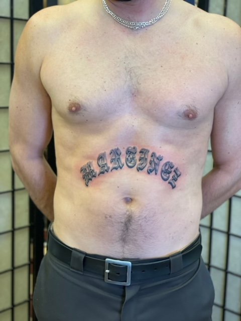 Old English across the stomach  Parlour Tattoo Studio  Facebook