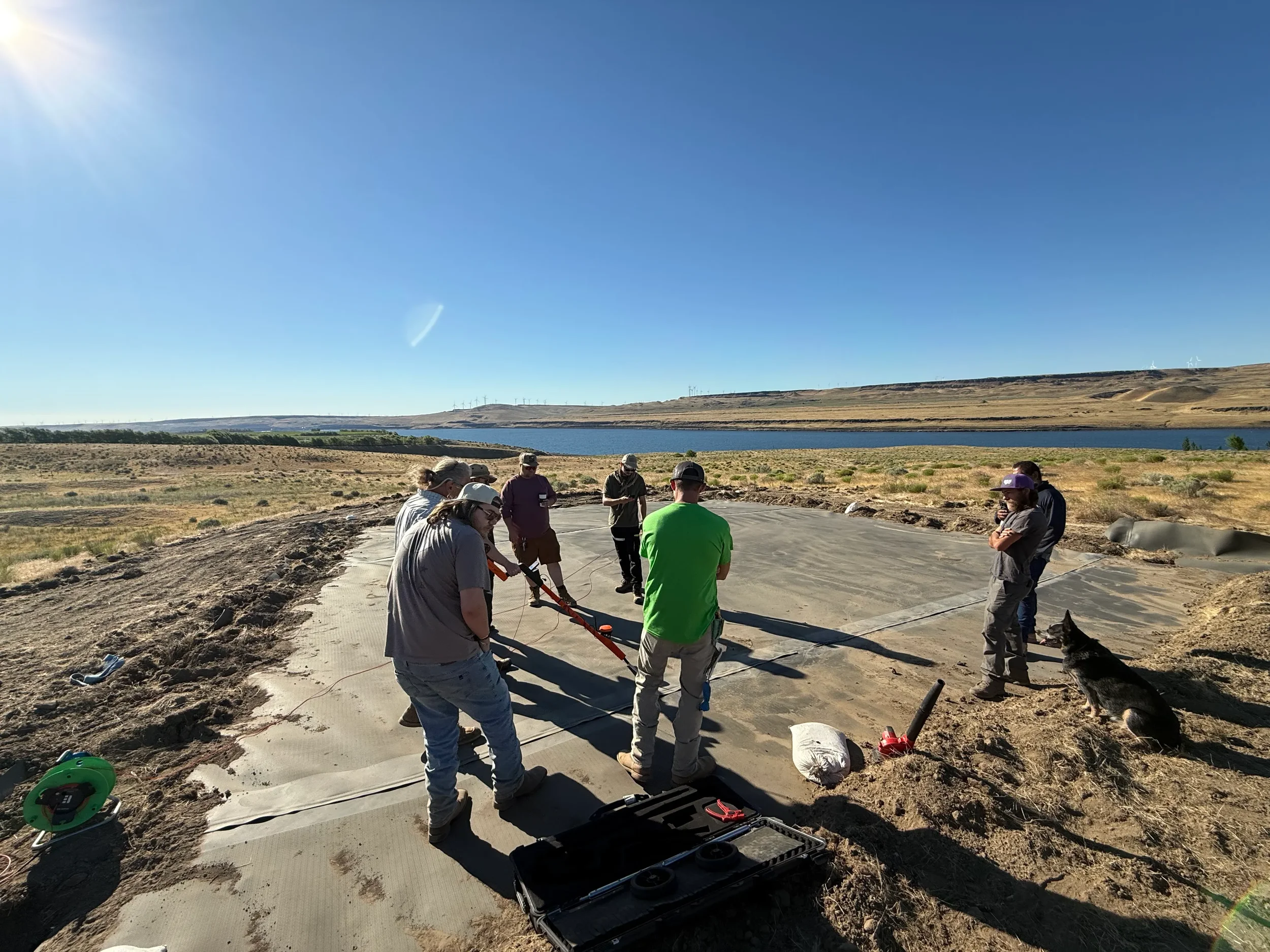 Geosynthetic Advisors crew conducting electrical leak location testing on geomembrane liner, verifying containment system integrity before service