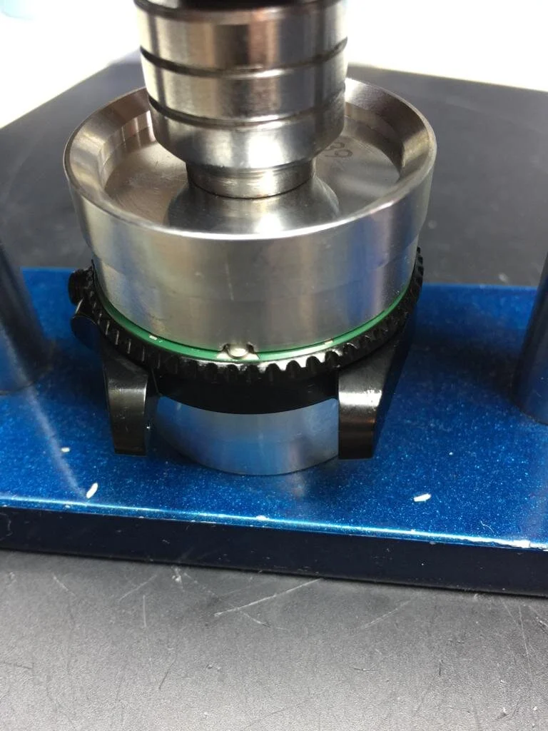 Rolex bezel insert being pressed.jpeg