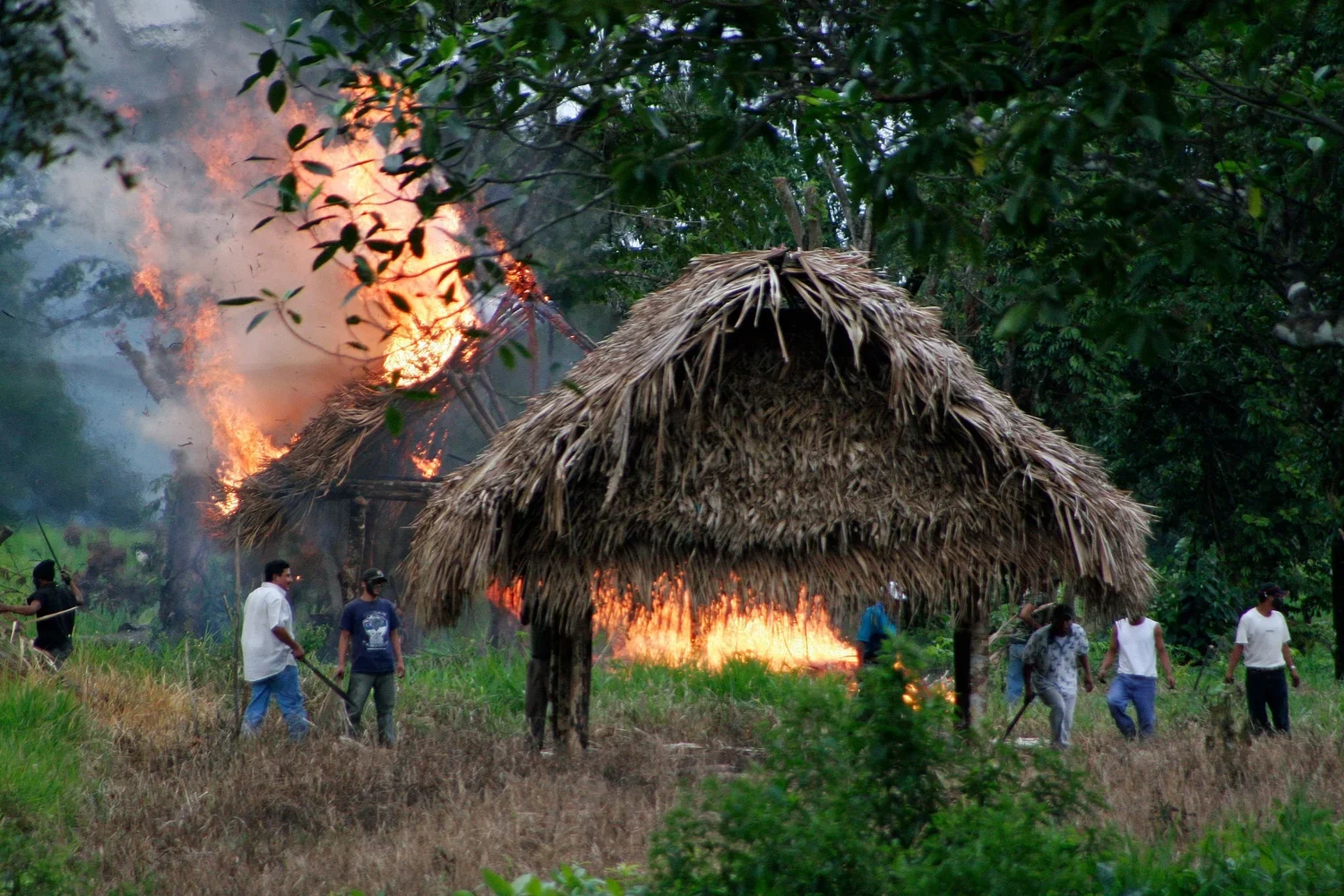 Figure 4. Eviction of Barrio La Revolución. Hired men from the nearby community of Mariscos burn homes at Barrio La Revolución. On January 7, 8, and 9, 2007, the Guatemalan Nickel Company, local subsidiary of Canadian Skye Resources, ordered the forc
