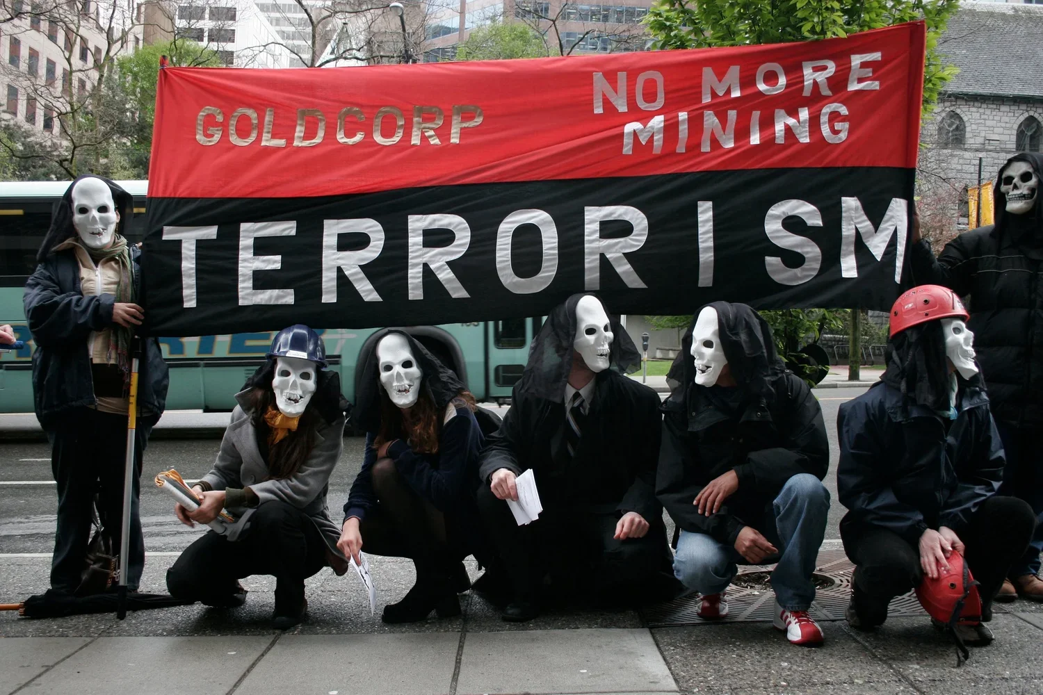 Figure 6. Protest During 2007 Goldcorp AGM. People protesting Goldcorp’s mining-linked violence and harms in Guatemala and Honduras gather outside the offices where Goldcorp’s annual general meeting is taking place with a sign that reads: “Goldcorp: 