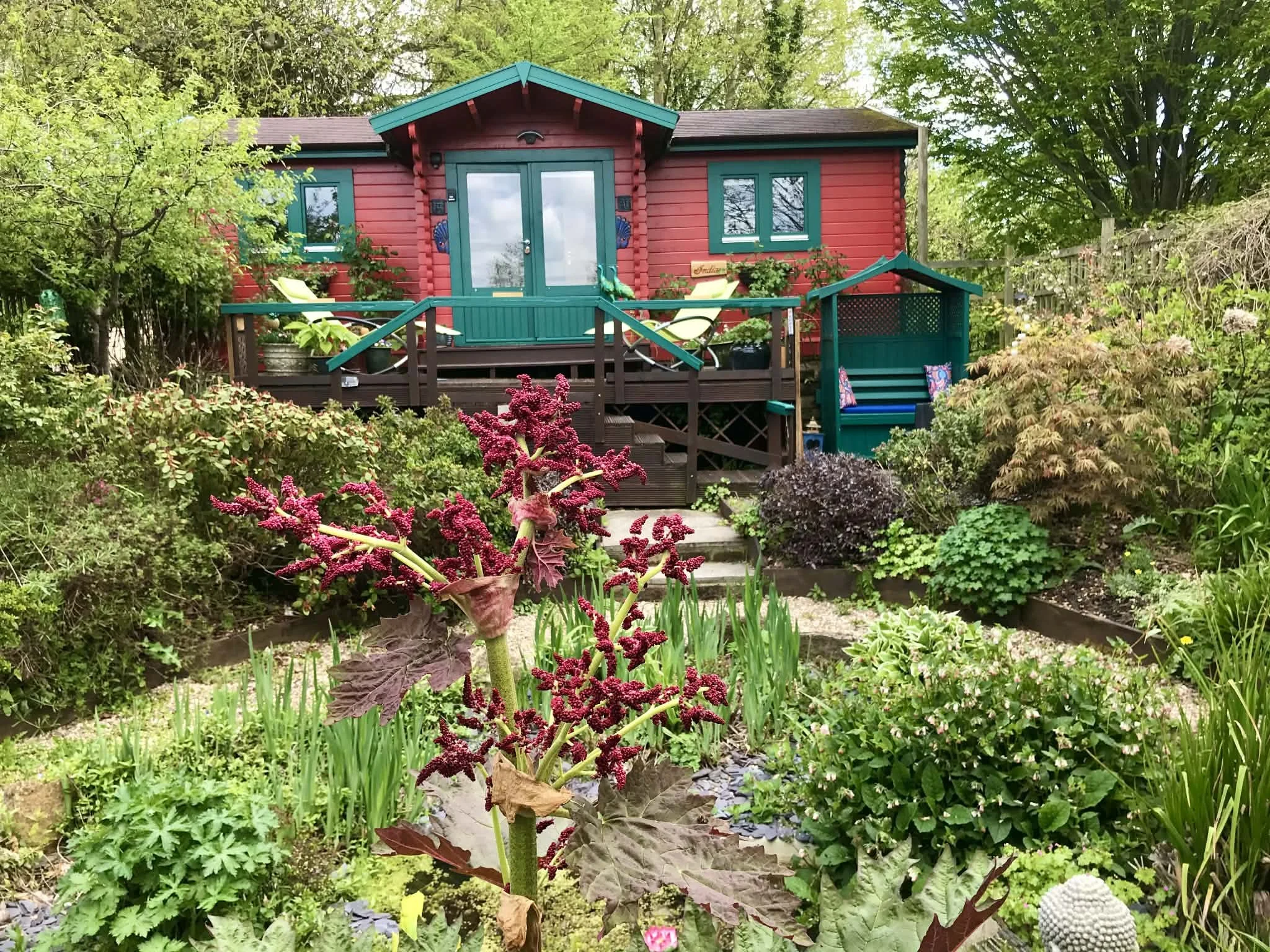 The beautiful red front of the one bedroom, self-catering, Little India chalet near Bridport