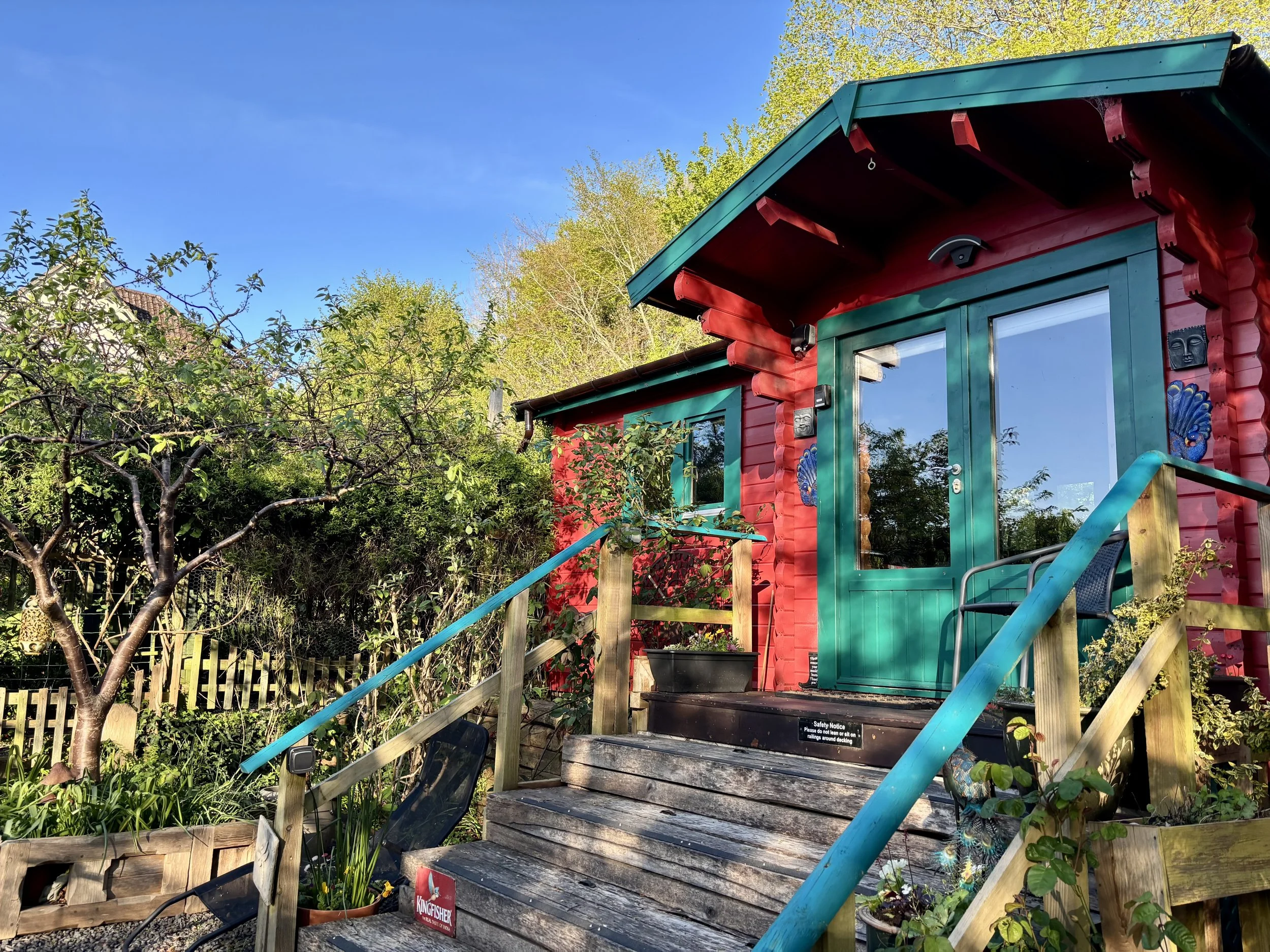 The beautiful red front of the one bedroom, self-catering, Little India chalet near Bridport