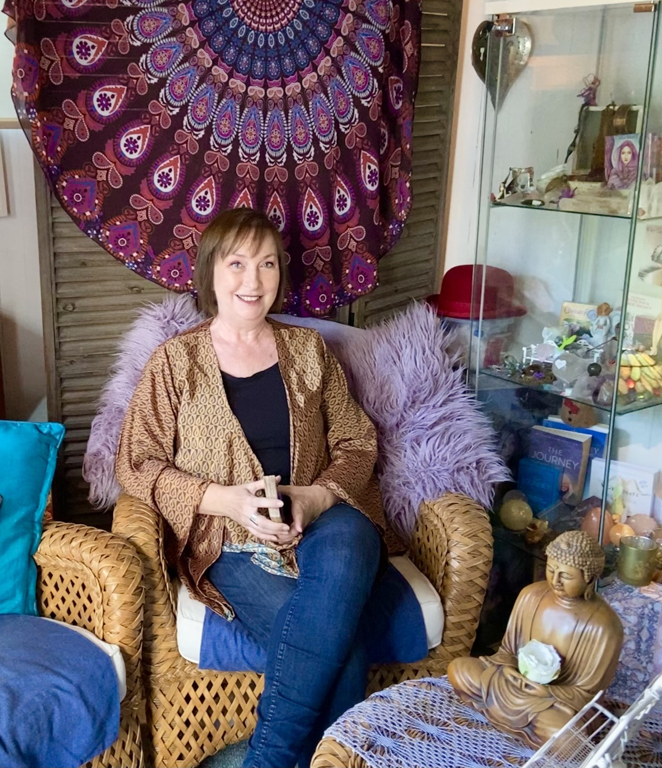 Nicky Williams sits in her healing space near Bridport Dorset