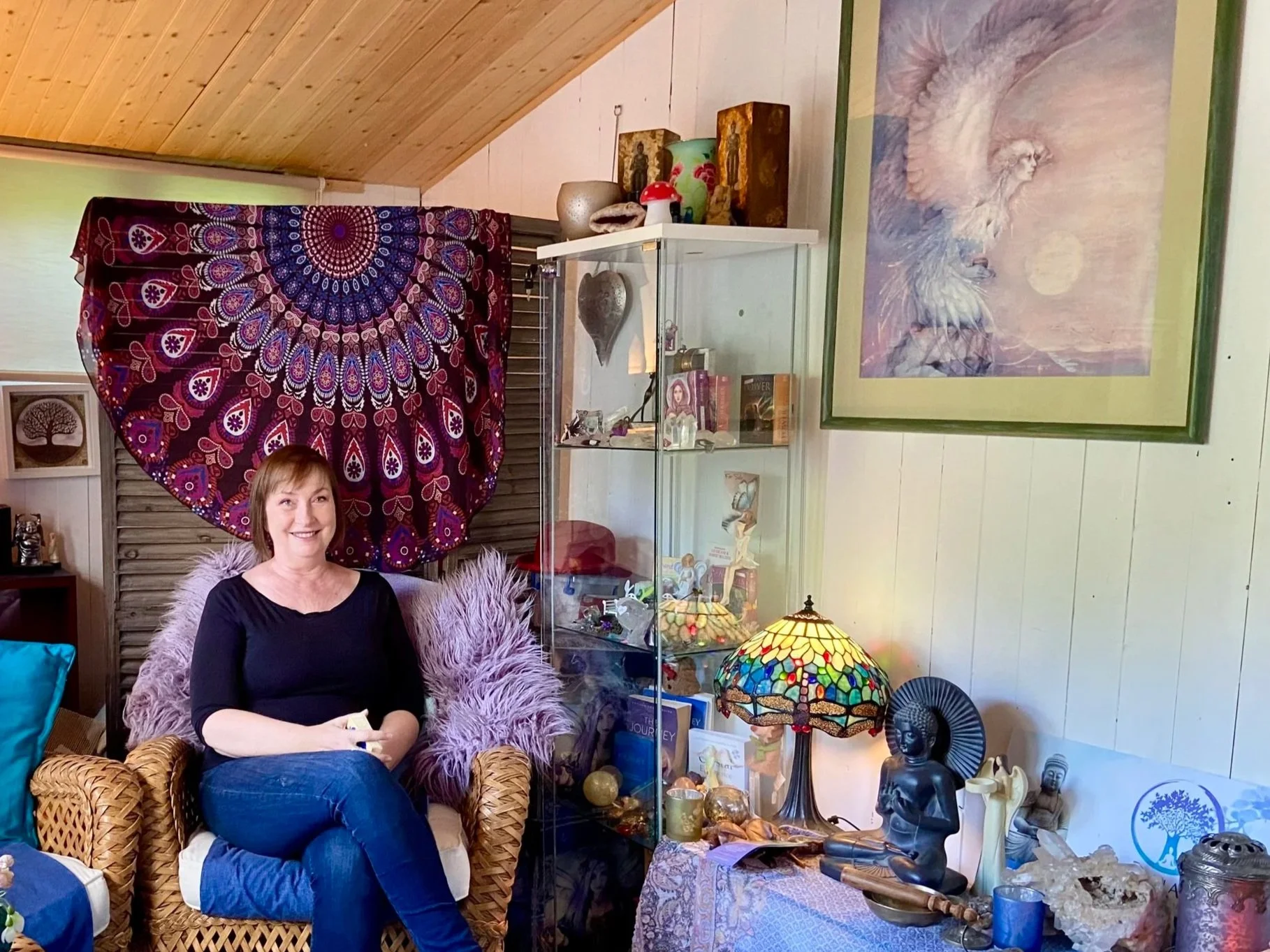Nicky Williams sitting in her practice room surrounded by her healing crystals